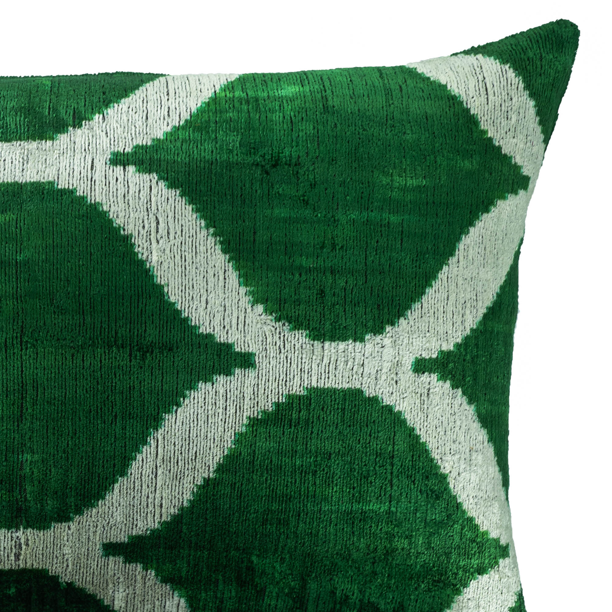Soft silk velvet Ikat pillow in green, showcasing a symmetrical white geometric motif.