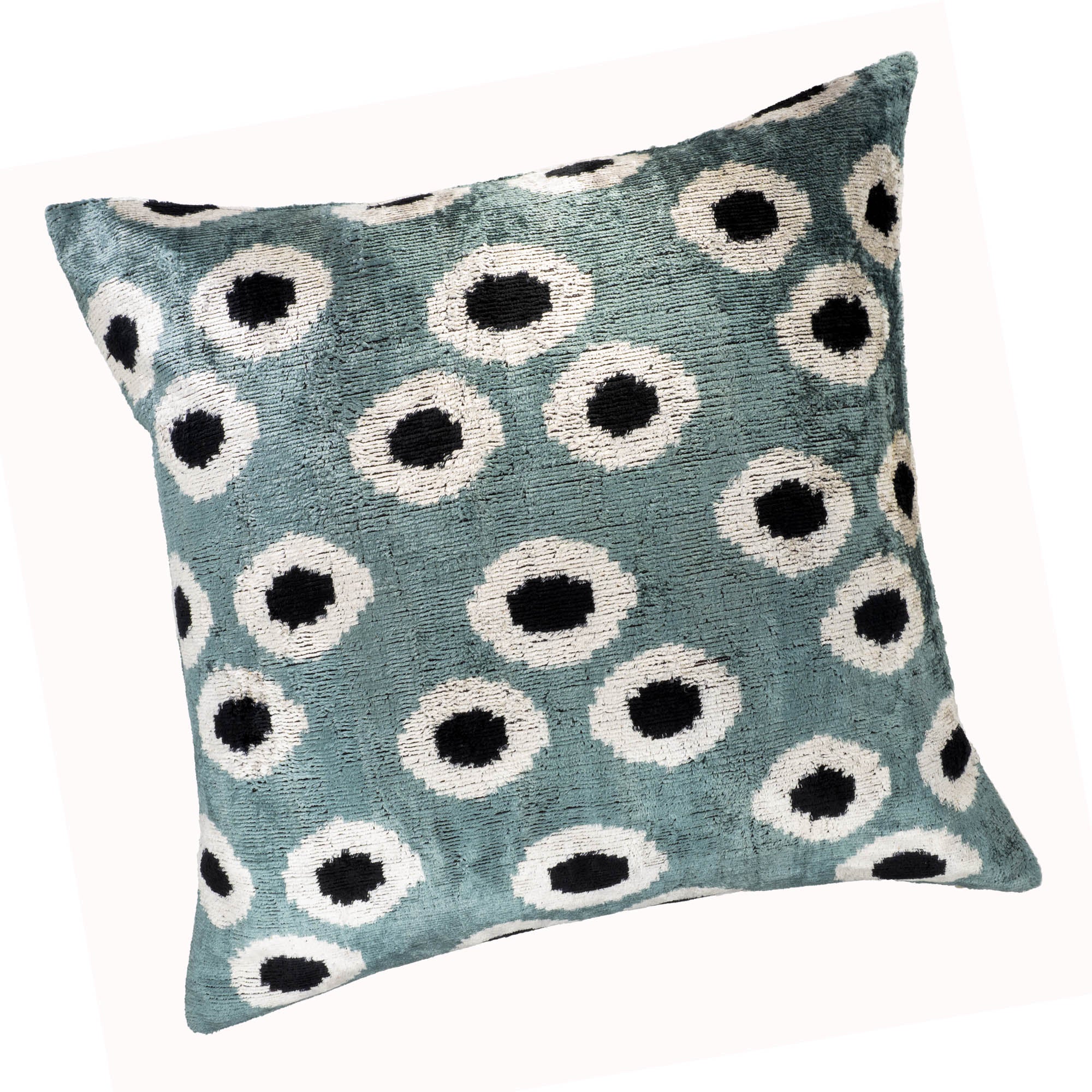 Handcrafted Ikat pillow cover with orb-shaped patterns, combining teal, white, and black tones in luxurious silk velvet.