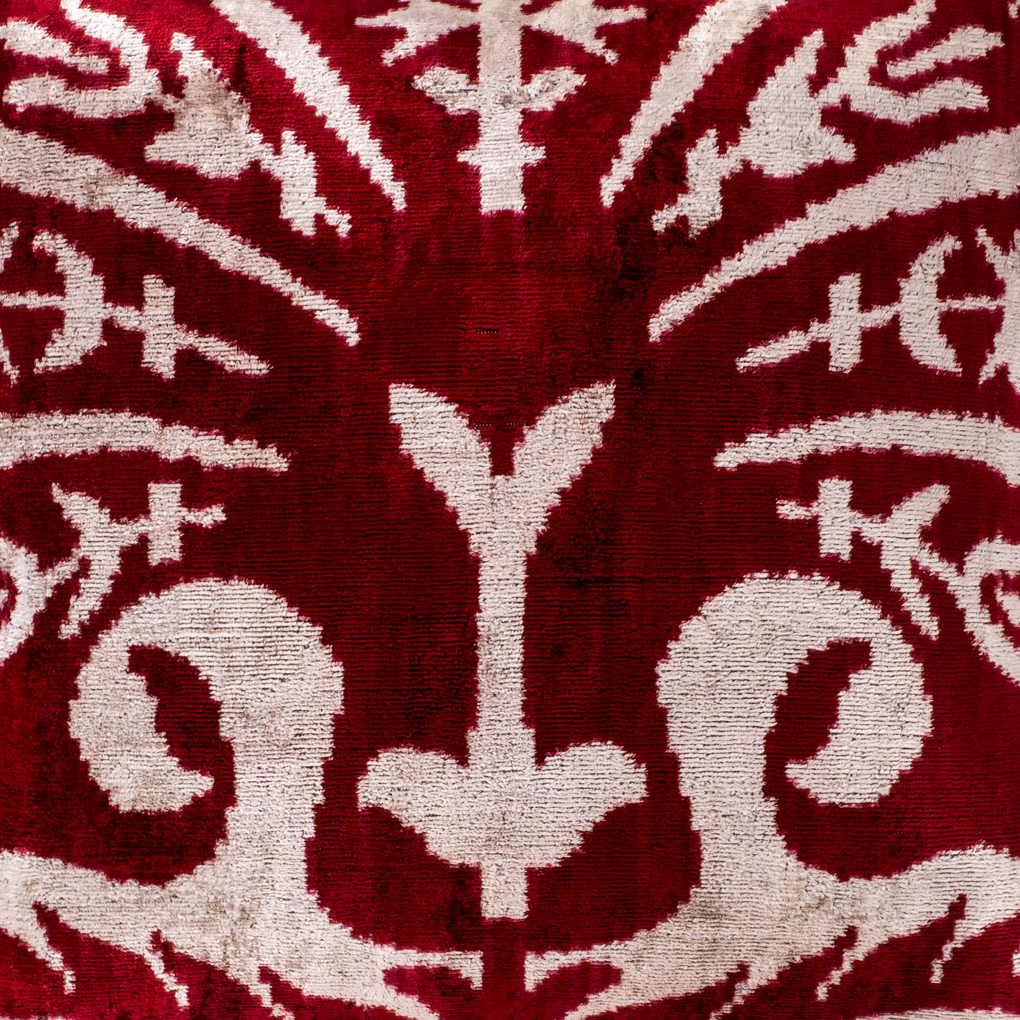Bold red Peacock Ikat pillow made from premium silk velvet, perfect for luxurious home decor.