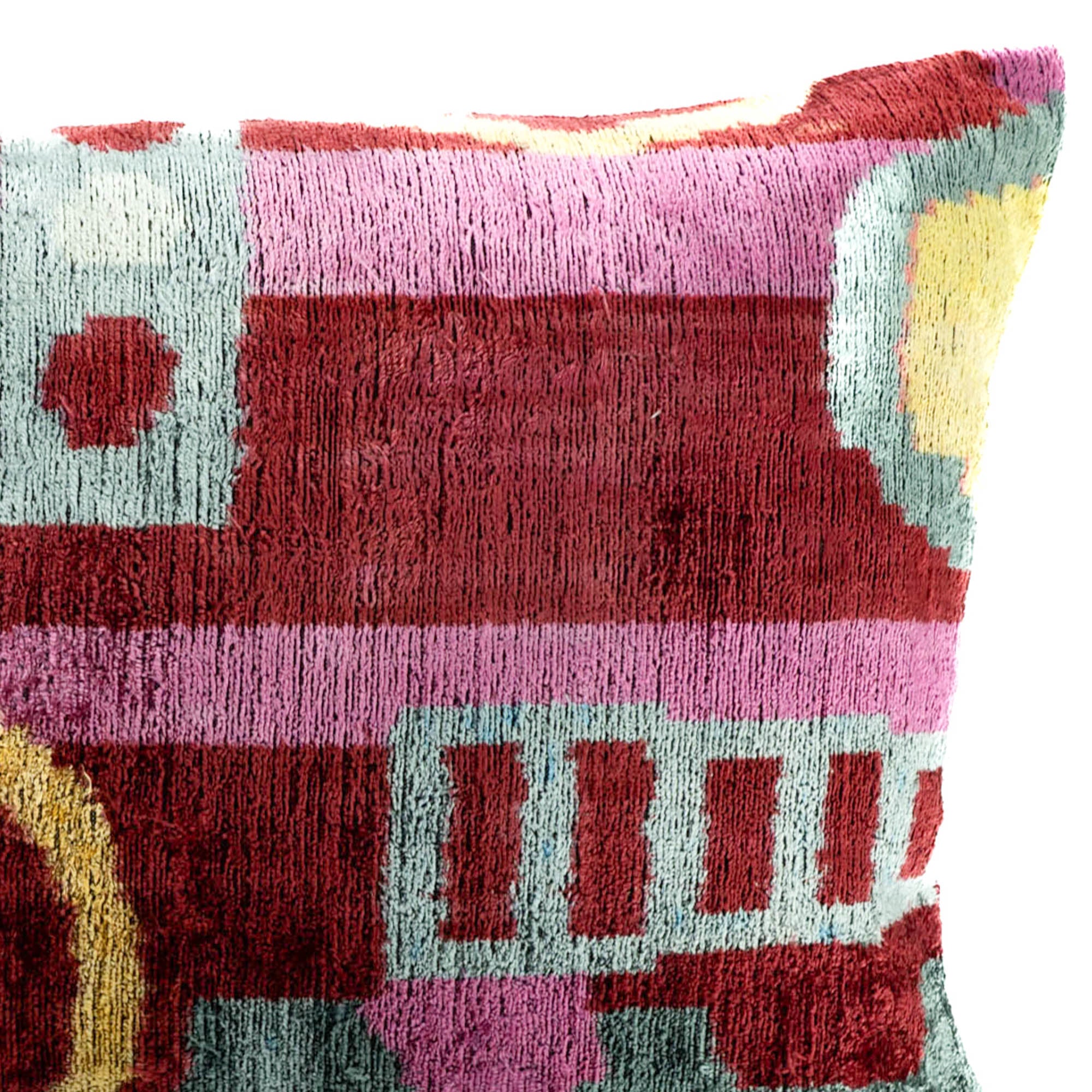 Pippa Silk Velvet pillow by Chouchou Touch, showcasing a unique design in vibrant red, pink, and teal tones.