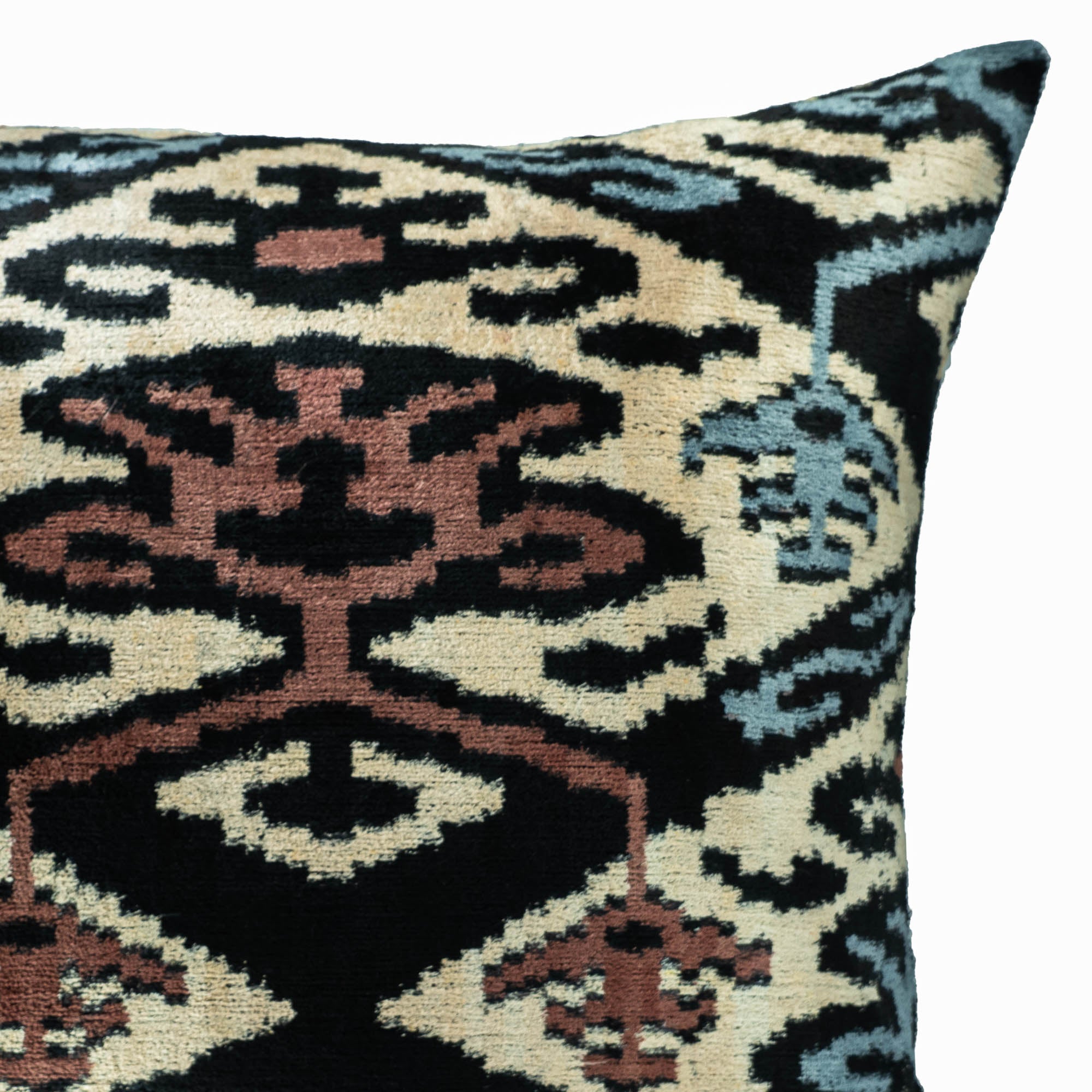 Regina Silk Velvet Ikat Pillow with intricate patterns in contrasting tones, inspired by Uzbek weaving traditions.