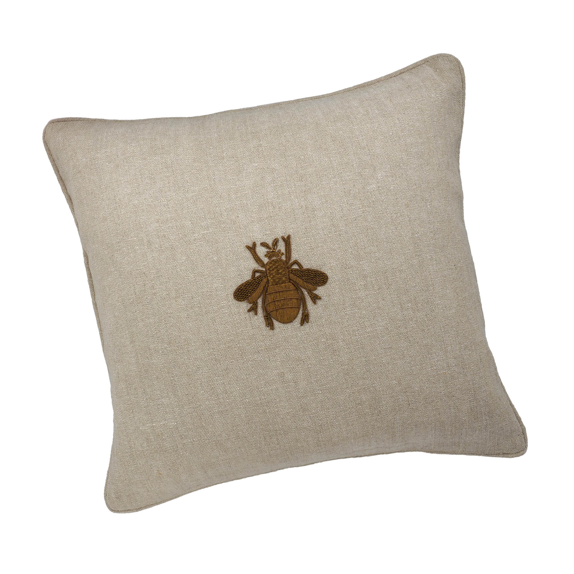 Square beige linen pillow with hand-embroidered metallic bee motif.