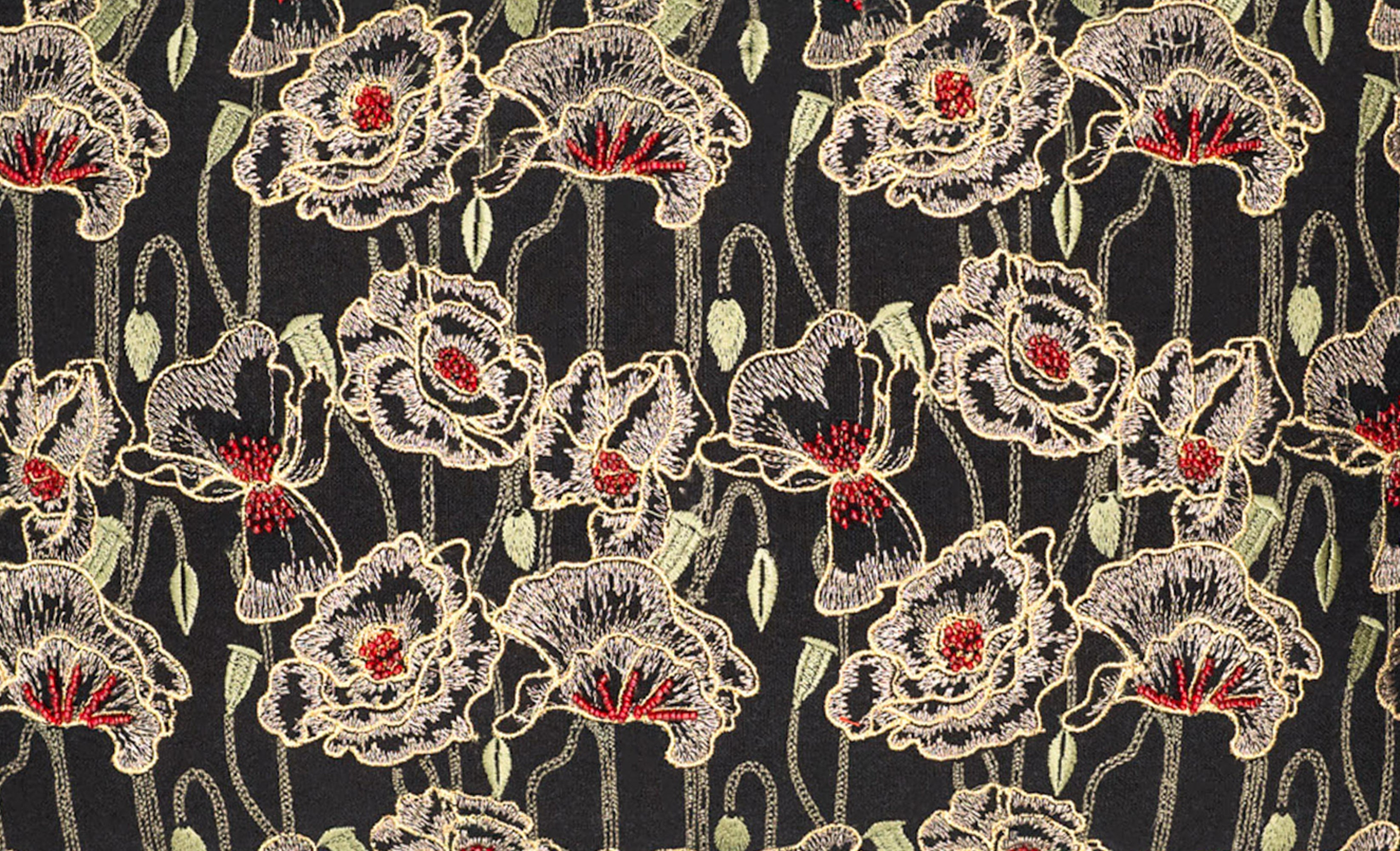 Close-up of Black Orchid pillow embroidery showing dimensional orchid details stitched with metallic threads on black linen fabric