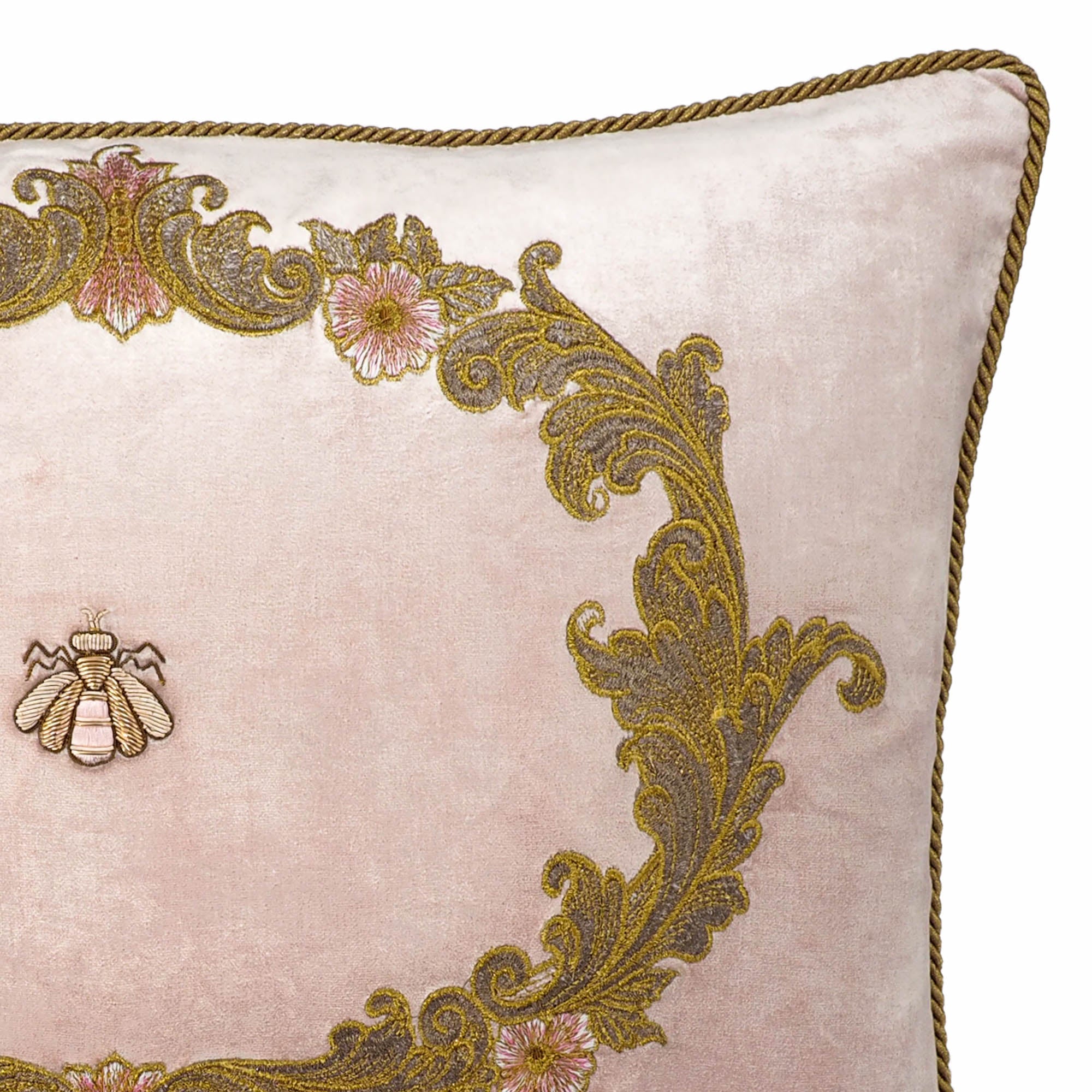 Luxurious pink velvet throw pillow adorned with central bee and detailed golden floral embroidery.