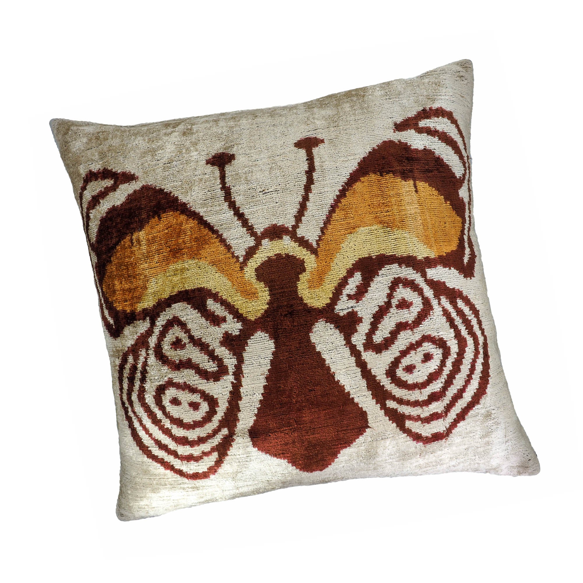 Handwoven silk velvet pillow with a symmetrical butterfly design in burnt orange and gold tones.