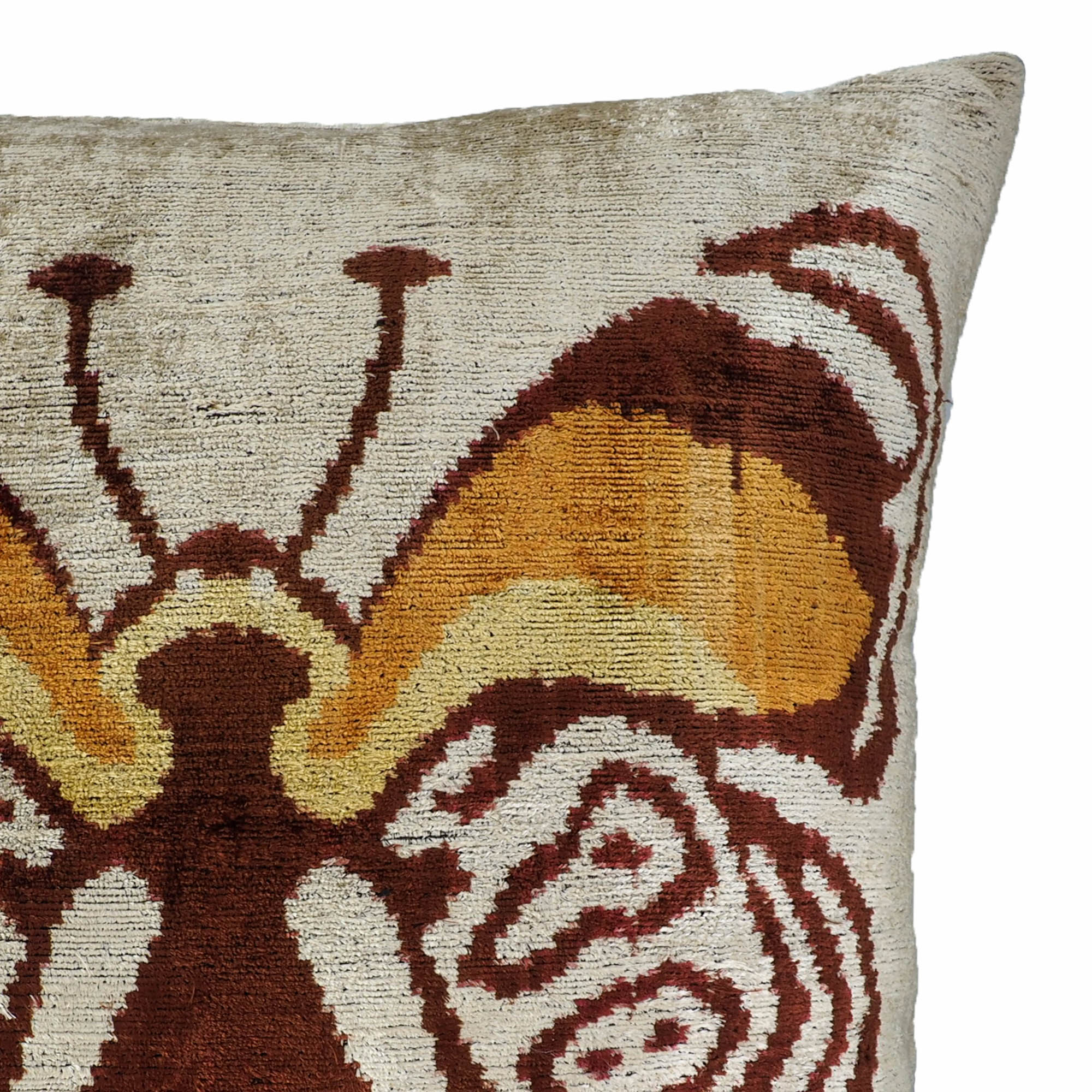 24-inch square ikat throw pillow featuring a striking butterfly motif on beige velvet background.