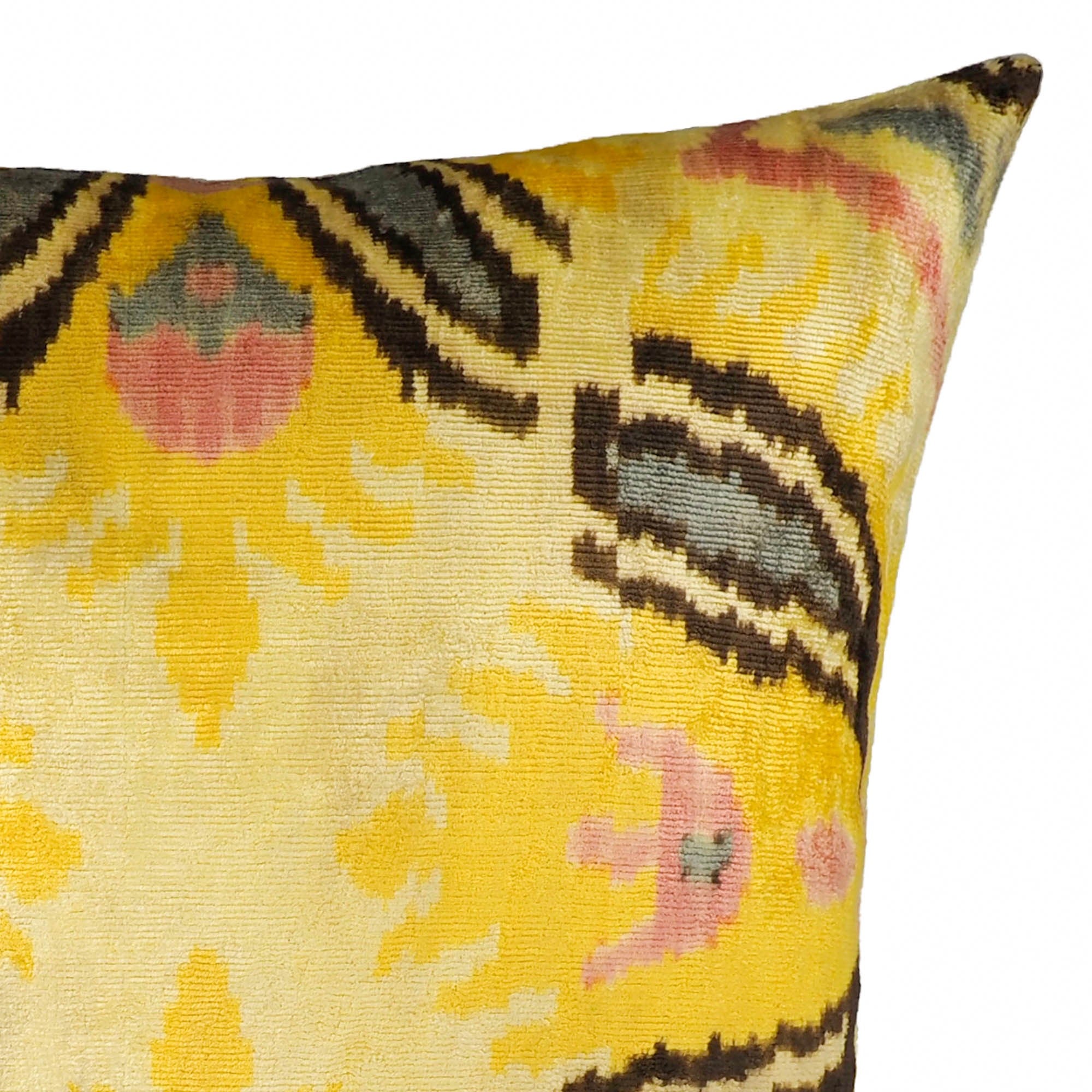 Square silk velvet cushion with radiant yellow background and stylized tulip-like ikat patterns.