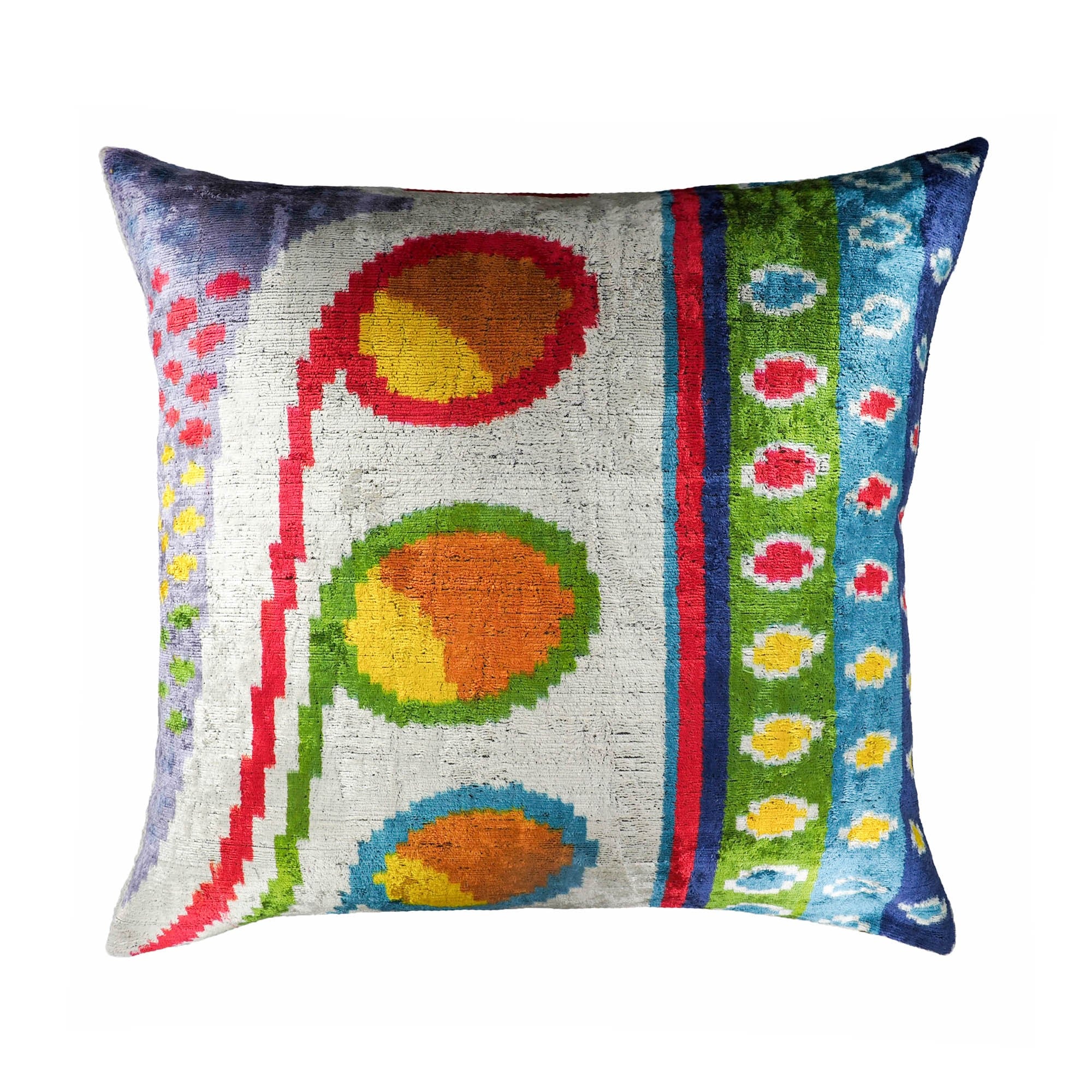 Colorful silk velvet pillow with playful ikat dots and stripes in red, green, blue, and orange.