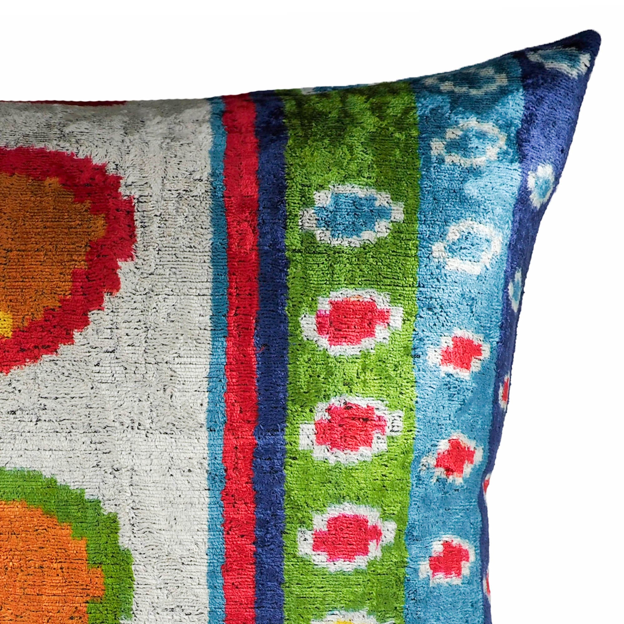 24x24 silk velvet throw pillow with festive multicolor ikat design and bold geometric shapes.