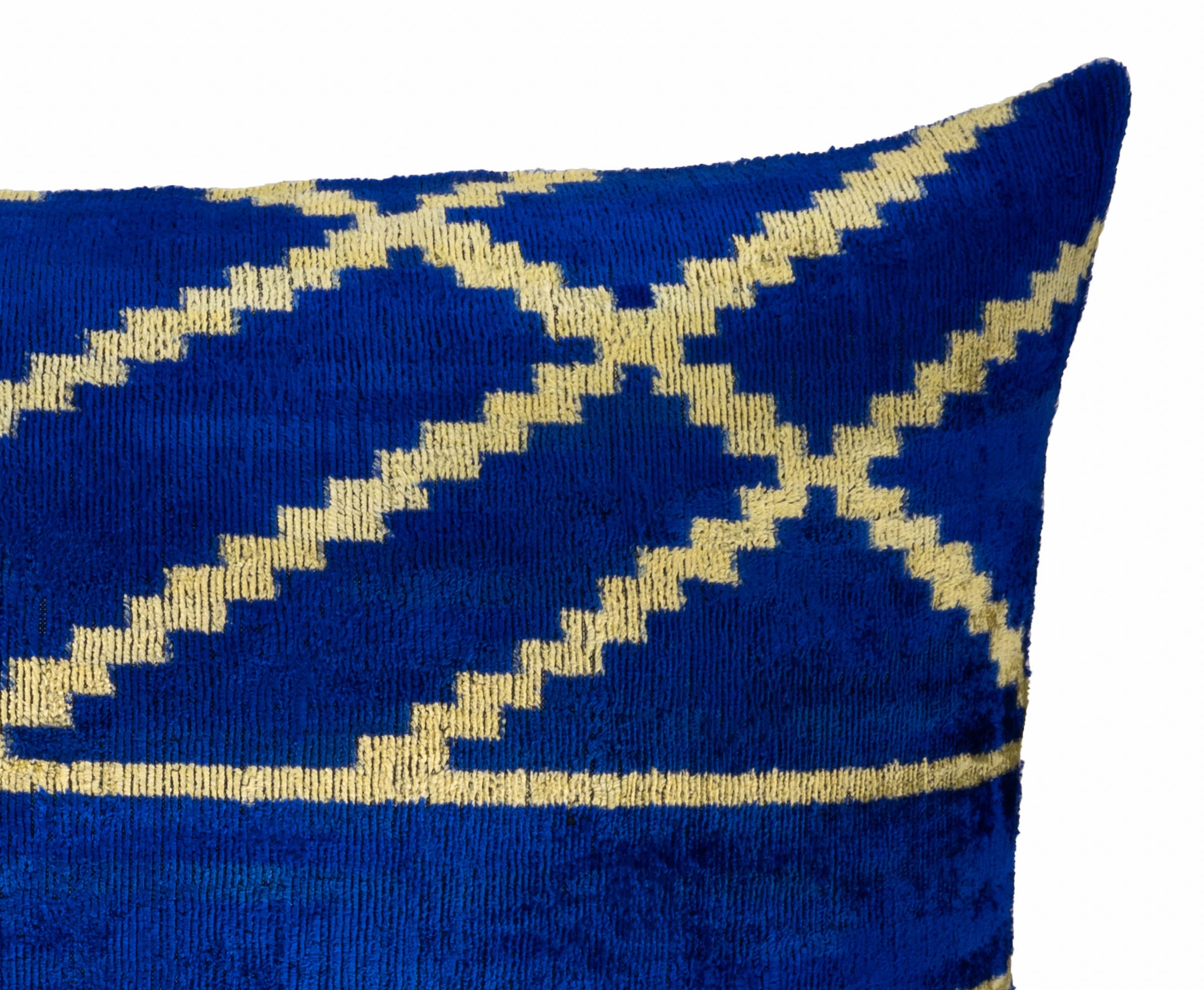 Blue silk velvet ikat cushion with geometric yellow lines and smooth sheen.