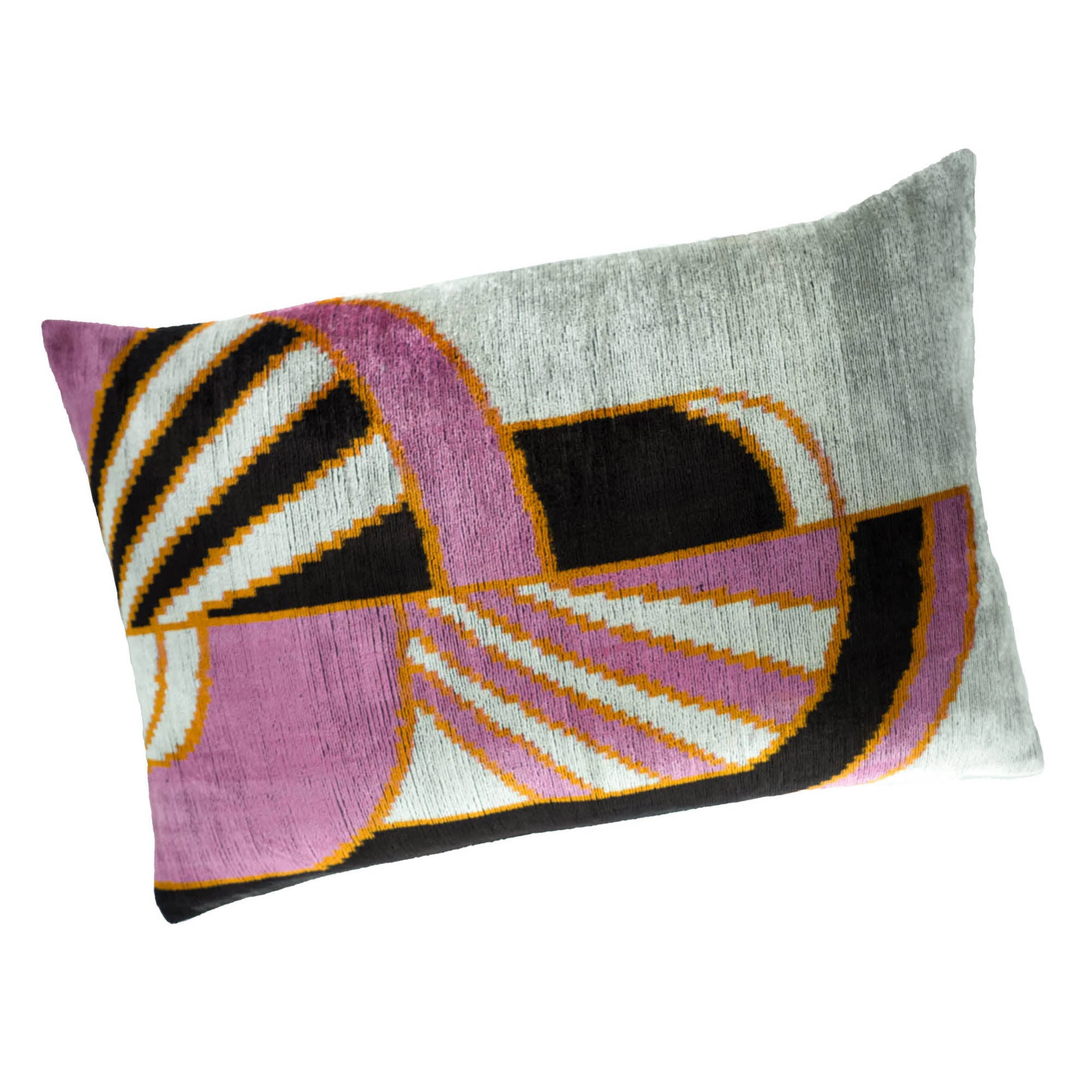 Luxurious Ikat pillow with striking abstract design in soft silk velvet, blending pink, black, and yellow tones.