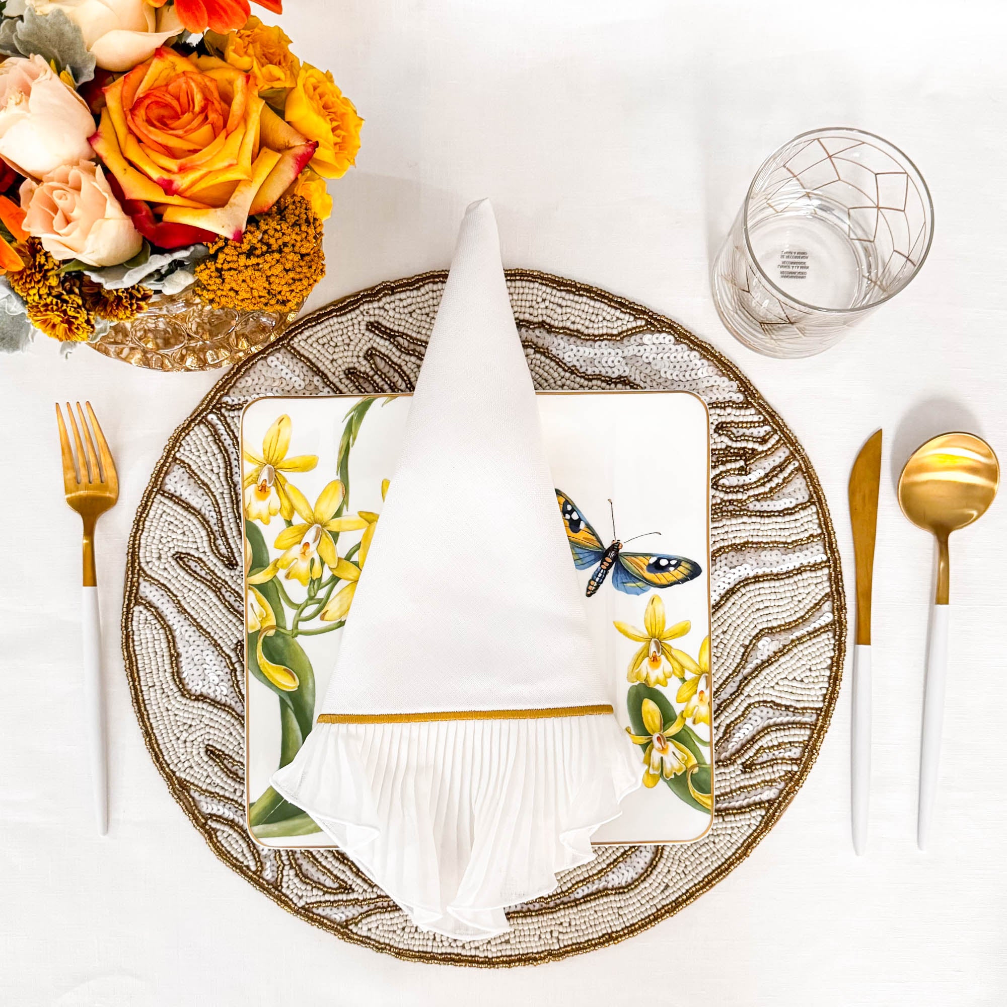 Close-up of handmade gold and ivory glass beaded placemat showing intricate artisanal beadwork by ChouChou Touch
