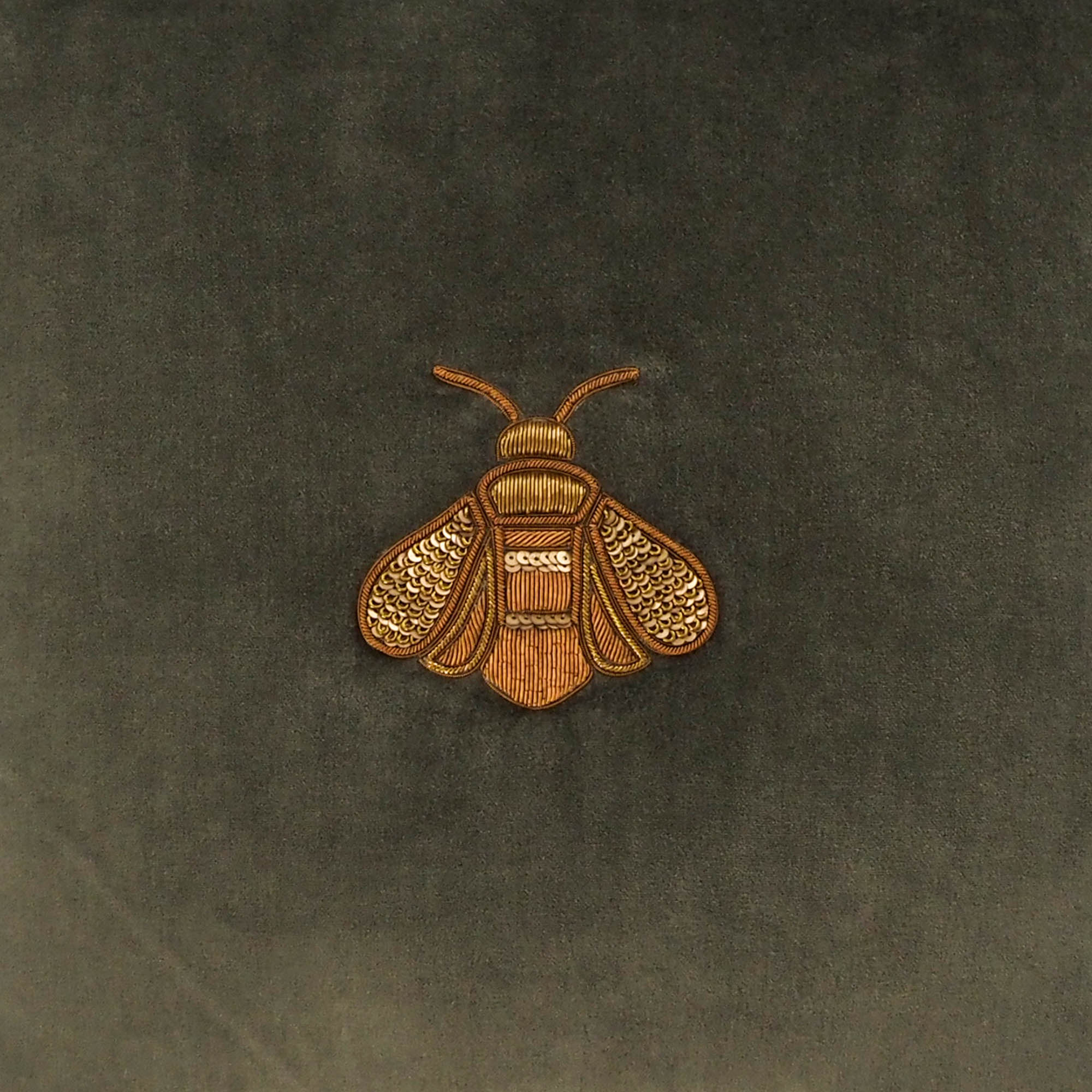 Chouchou Touch handcrafted green velvet pillow featuring a metallic bee motif.