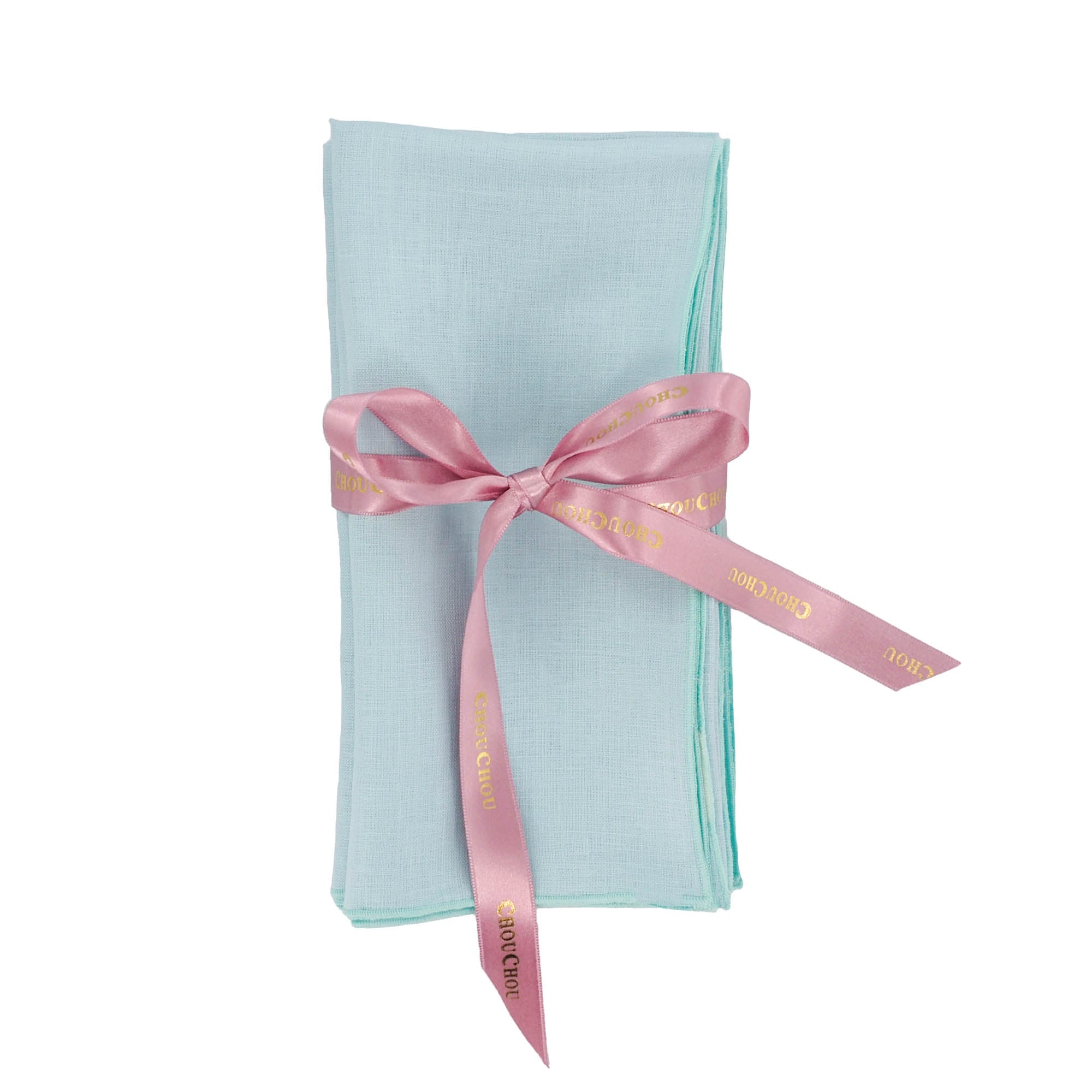 Luxury handmade light green linen napkin with a pink ribbon on a white background