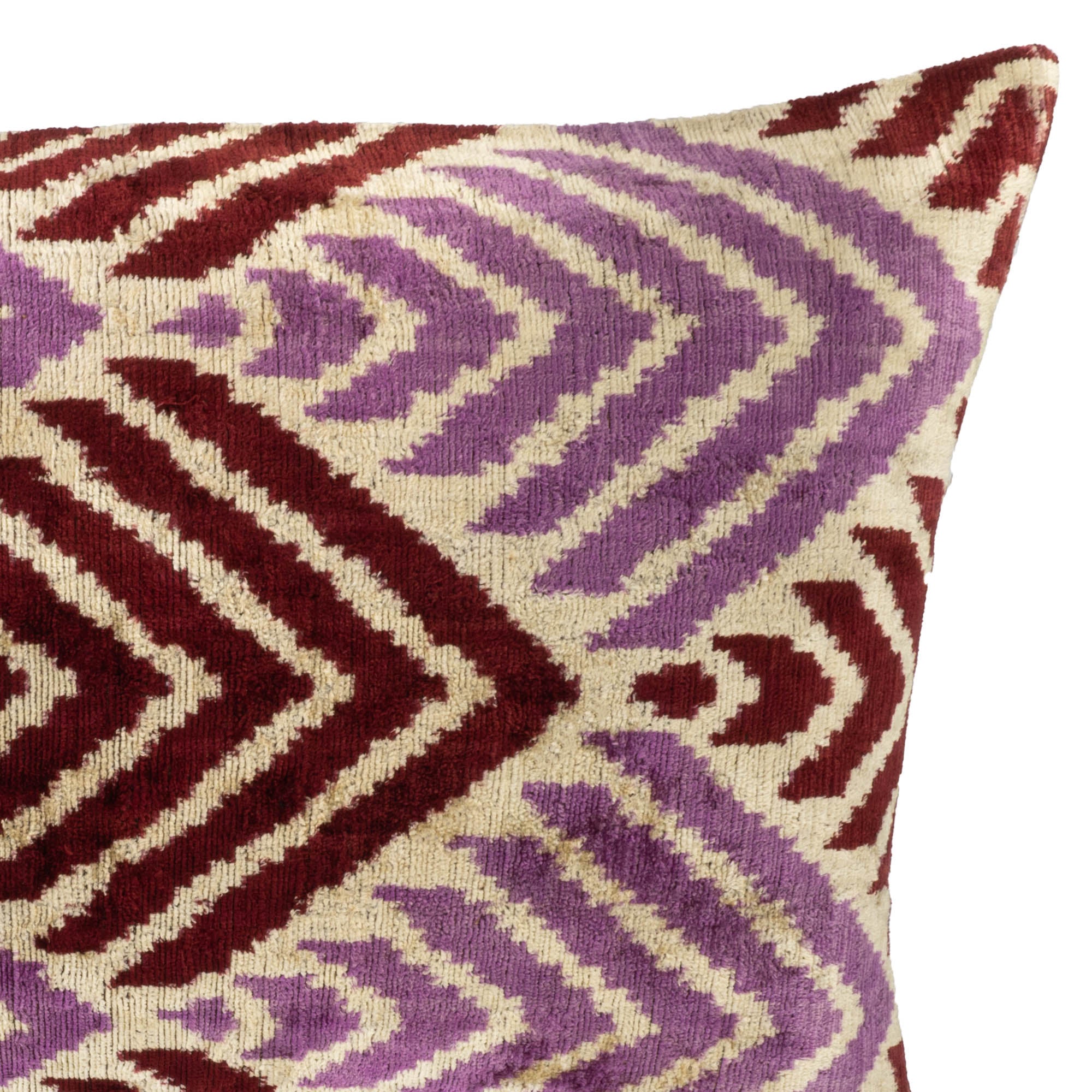 Chouchou Touch Journey throw pillow crafted from 100% silk velvet with bold chevron patterns in burgundy and lavender tones.