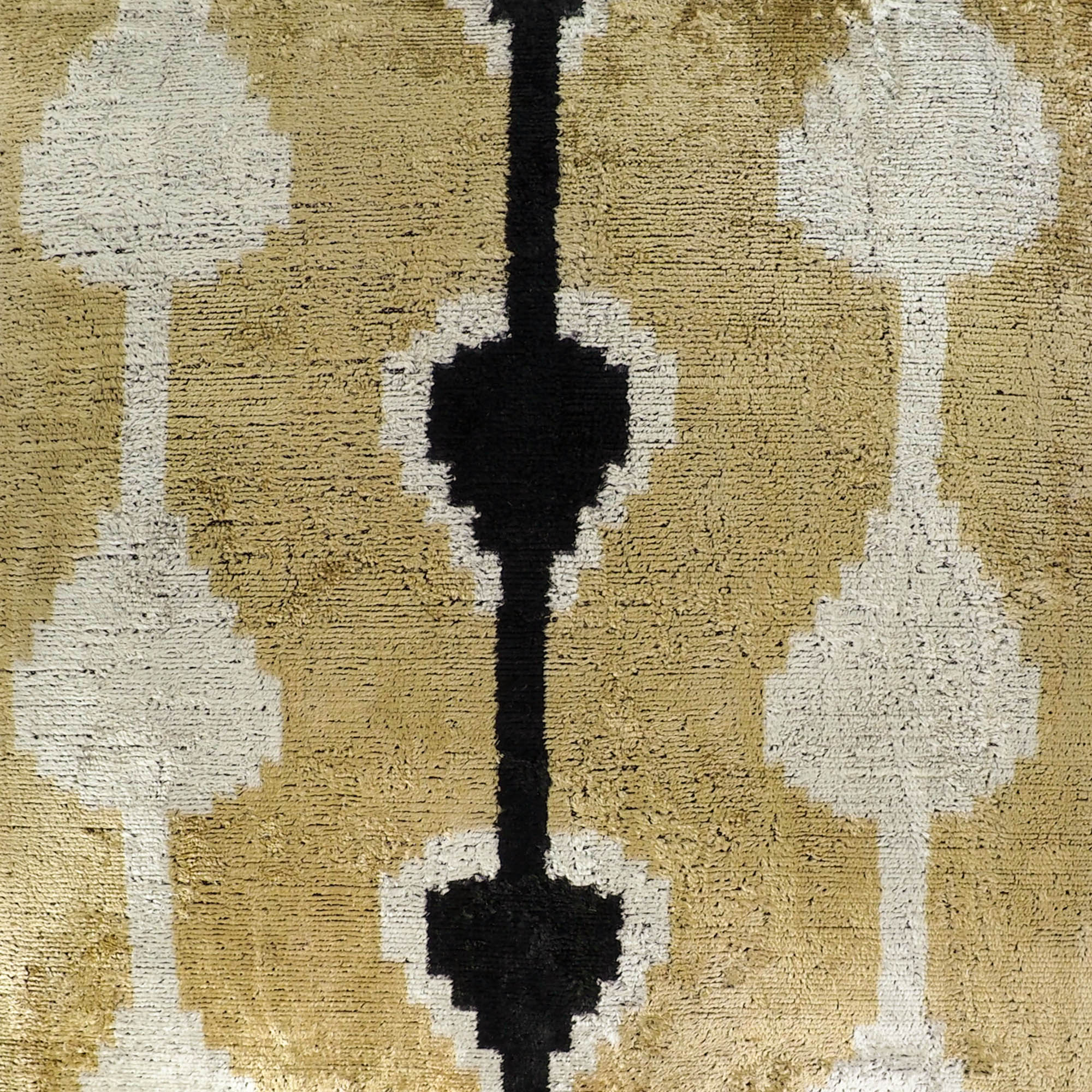 Chouchou Touch ikat pillow cover featuring vertical mirrored ikat design in gold and black.