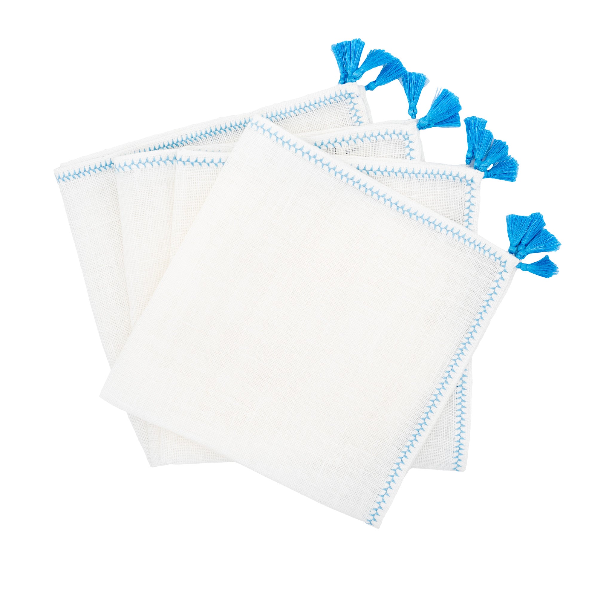 Handmade linen napkins with decorative blue tassels, perfect for both casual family gatherings and formal events.