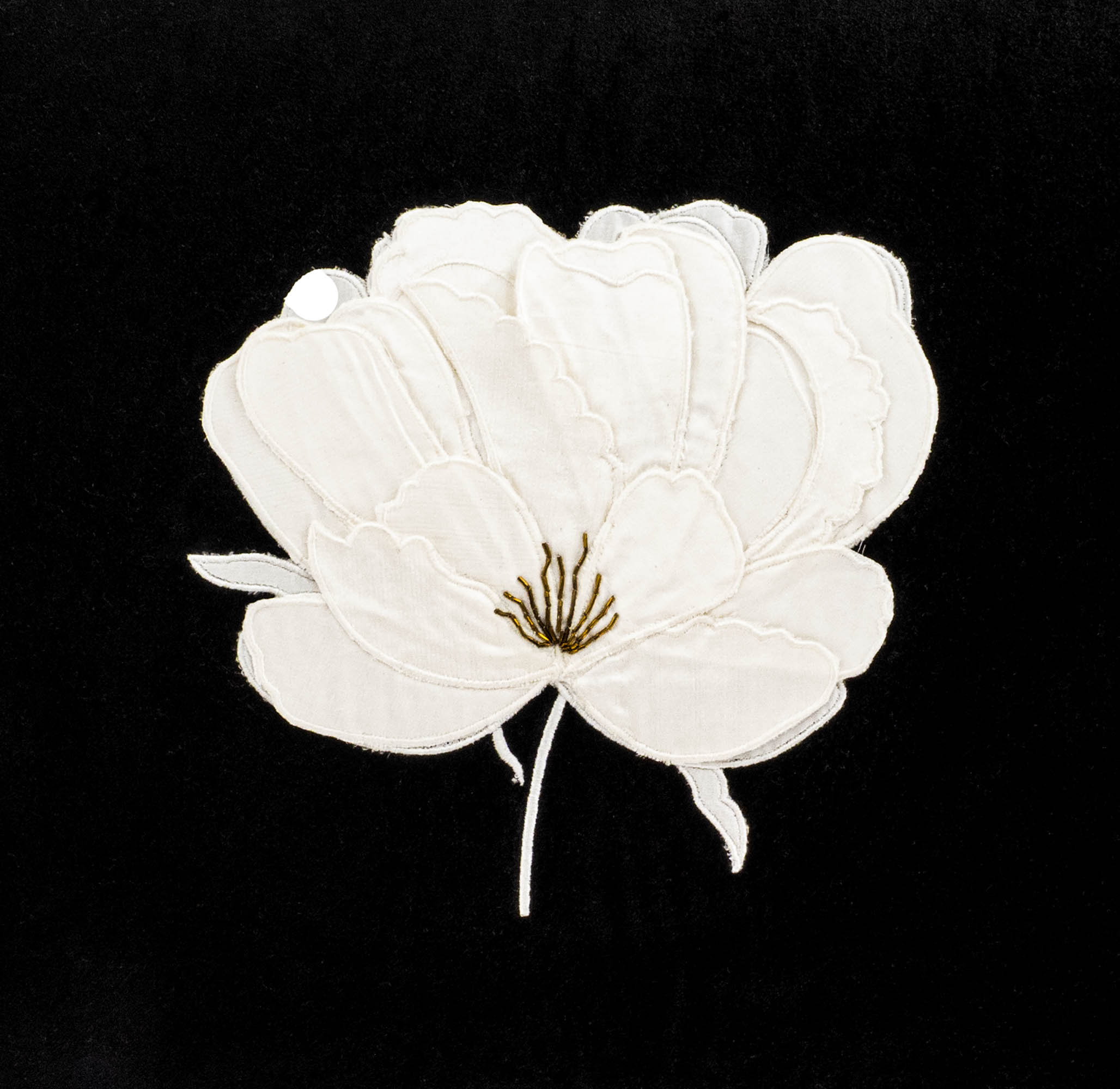 Rectangular black velvet throw pillow featuring white lotus motif in silk embroidery.