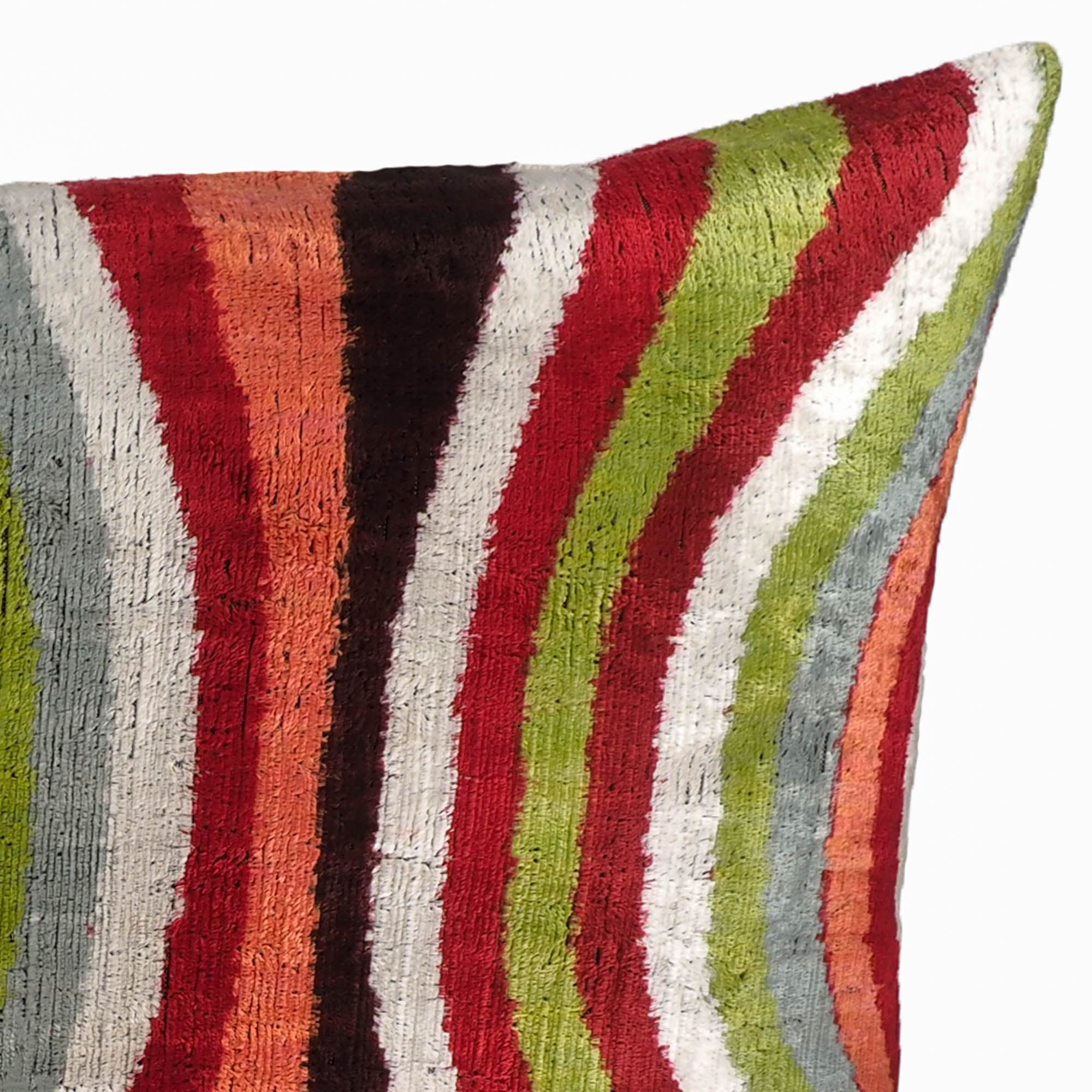 Handwoven silk velvet cushion with hypnotic ripple pattern in bold tones.