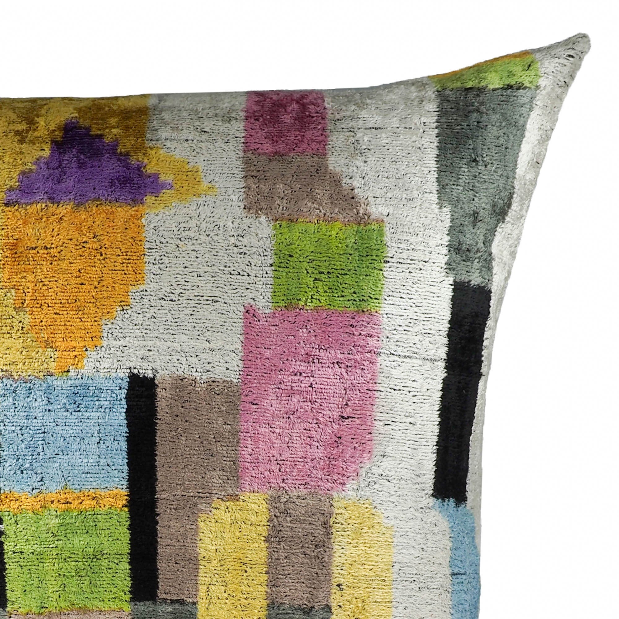 24x24 silk velvet cushion with contemporary ikat pattern in bright geometric shapes and playful colors.