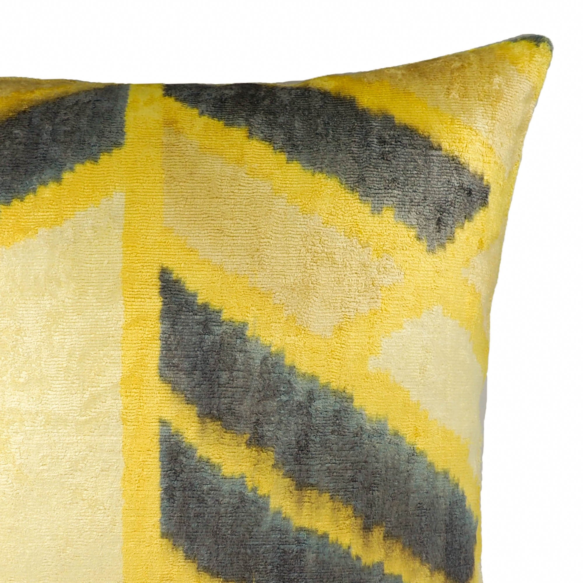Chouchou Touch decorative pillow featuring angular ikat lines in golden yellow and slate tones.