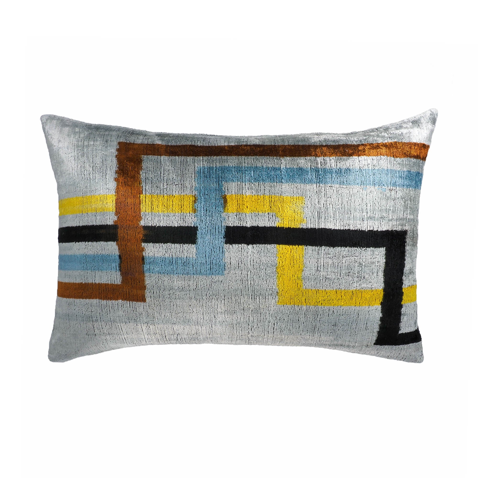 Rectangular ikat throw pillow in grey silk velvet with geometric interlocking blocks in yellow, blue, and black.