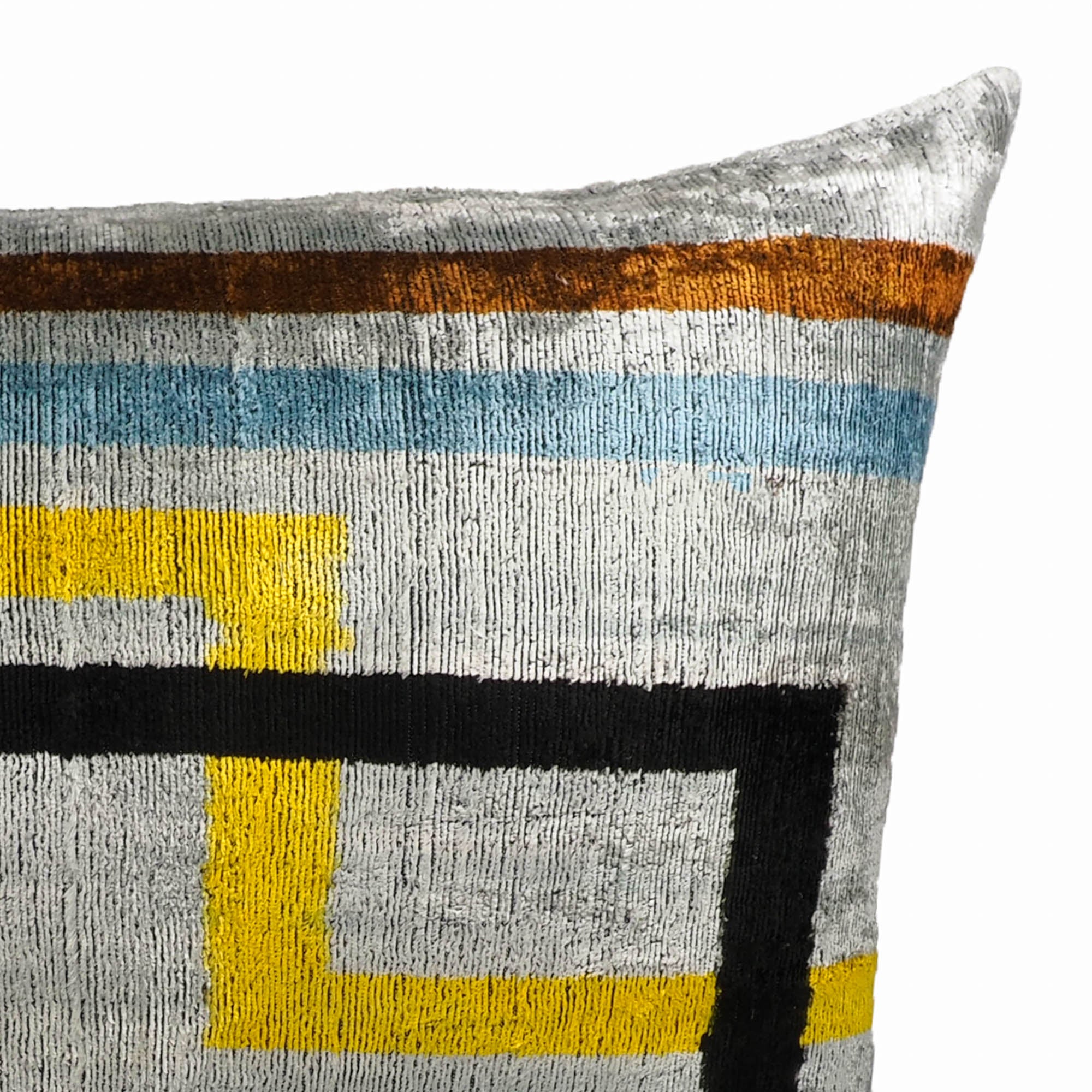 Olympia silk velvet pillow with abstract multicolored geometric print on a soft silver background.