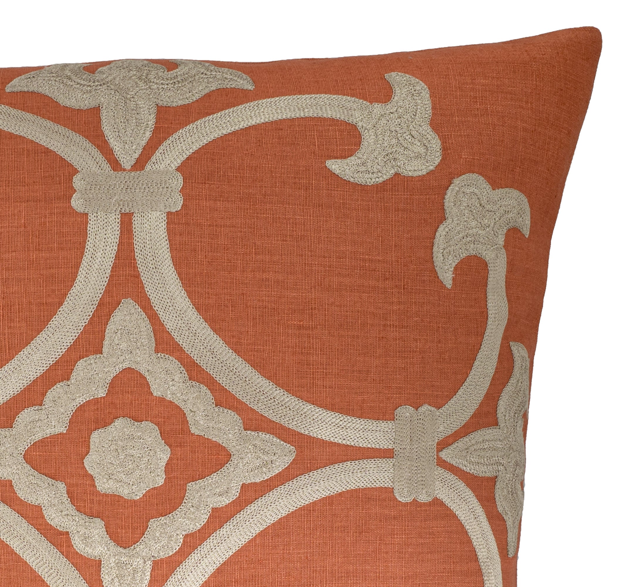 Decorative pillow with orange and beige pattern on a white background