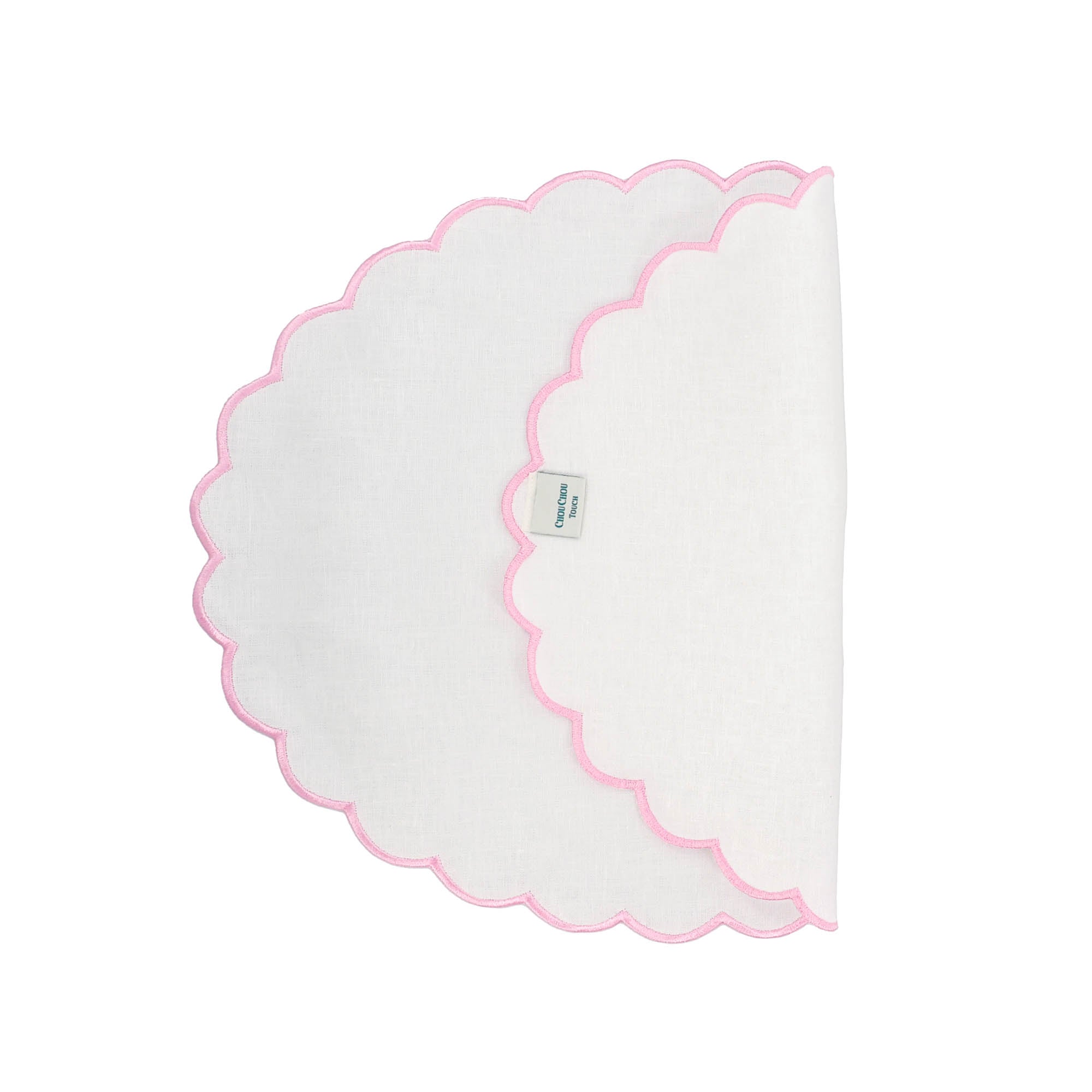 Set of 4 handcrafted pink linen placemats with scalloped edges, made from 100% linen for a soft, luxurious feel.