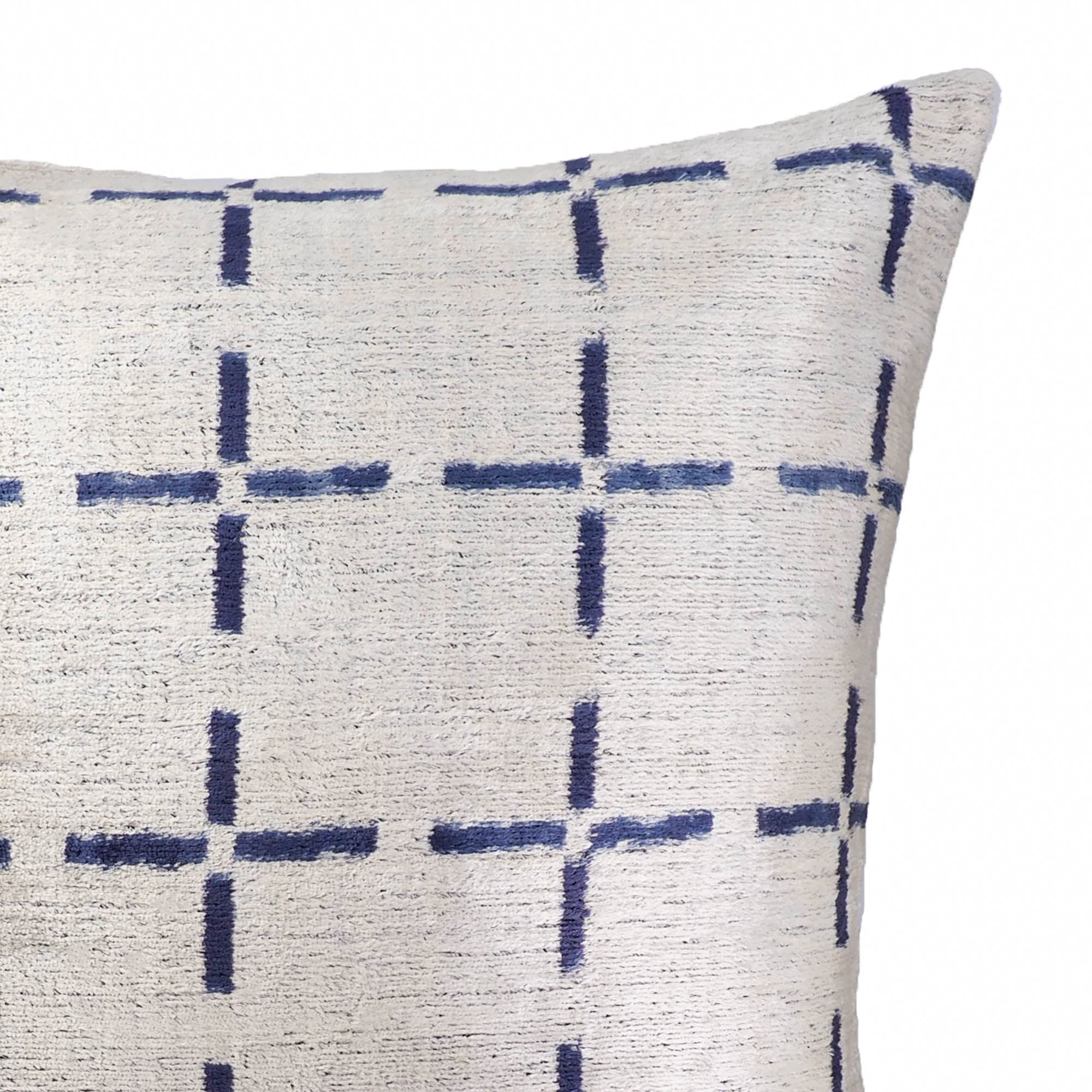 Handwoven silk velvet ikat cushion with modern geometric cross motifs in blue and cream.
