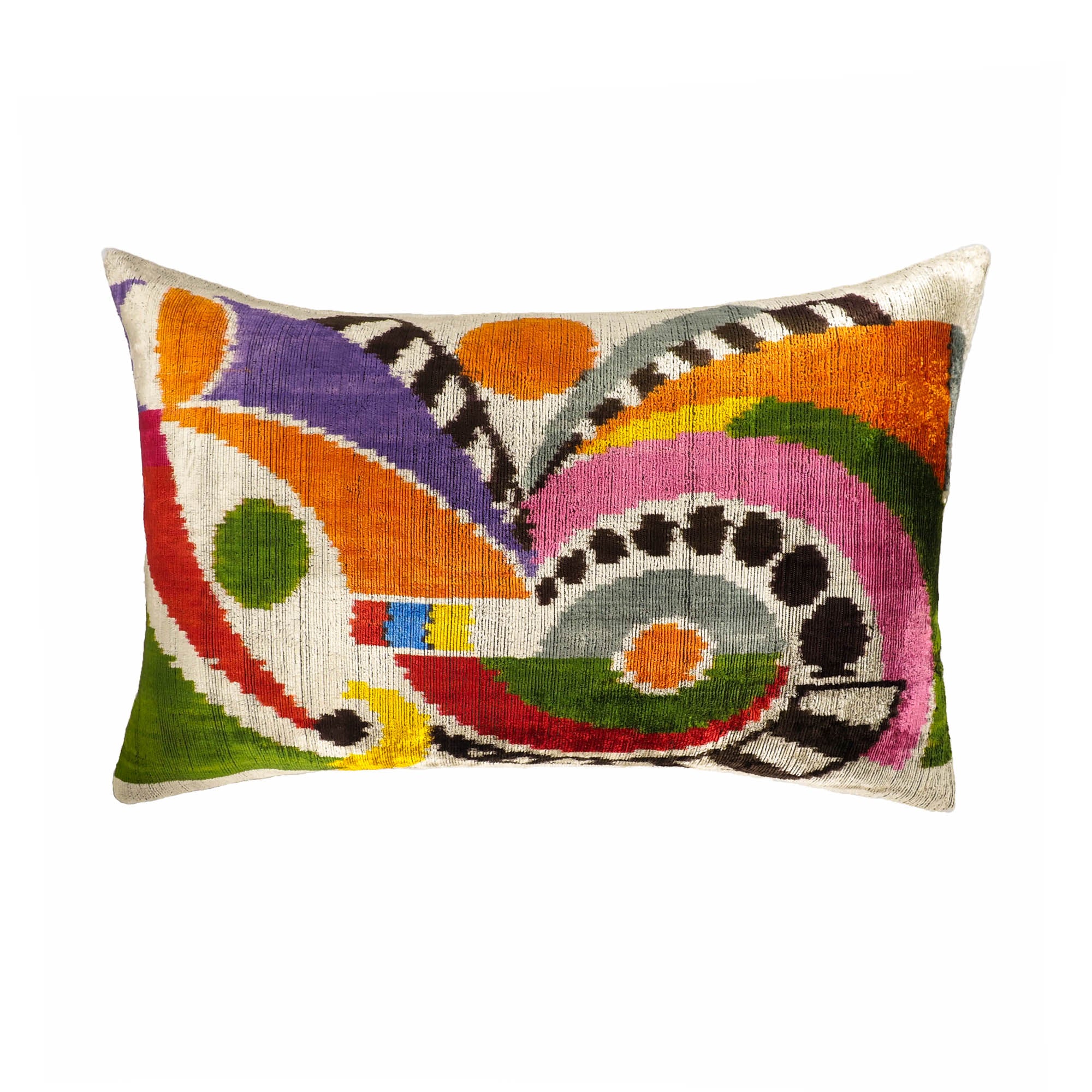Silk velvet ikat throw pillow featuring bold, abstract patterns in rainbow colors.