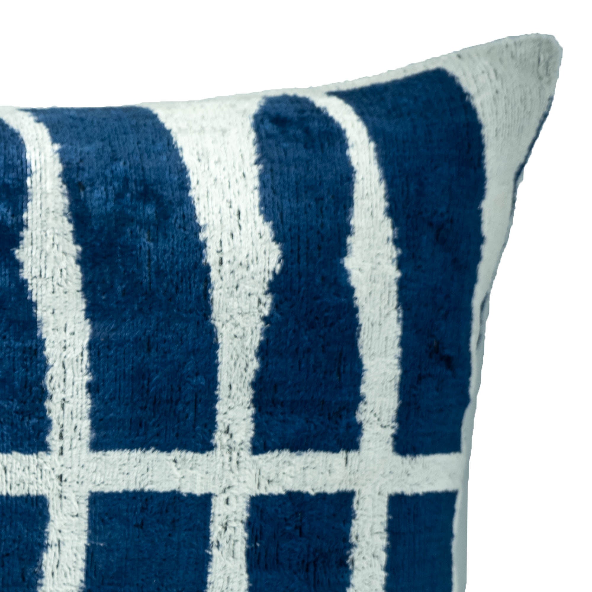 Modern Reflections Ikat pillow featuring a deep navy blue background with crisp white geometric lines.
