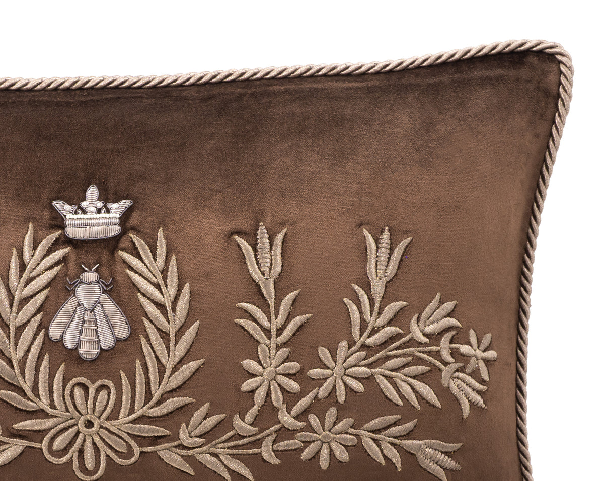 Close-up of crowned bee and floral embroidery on Regina brown silk velvet, showing the textured stitching and twisted cord edging.