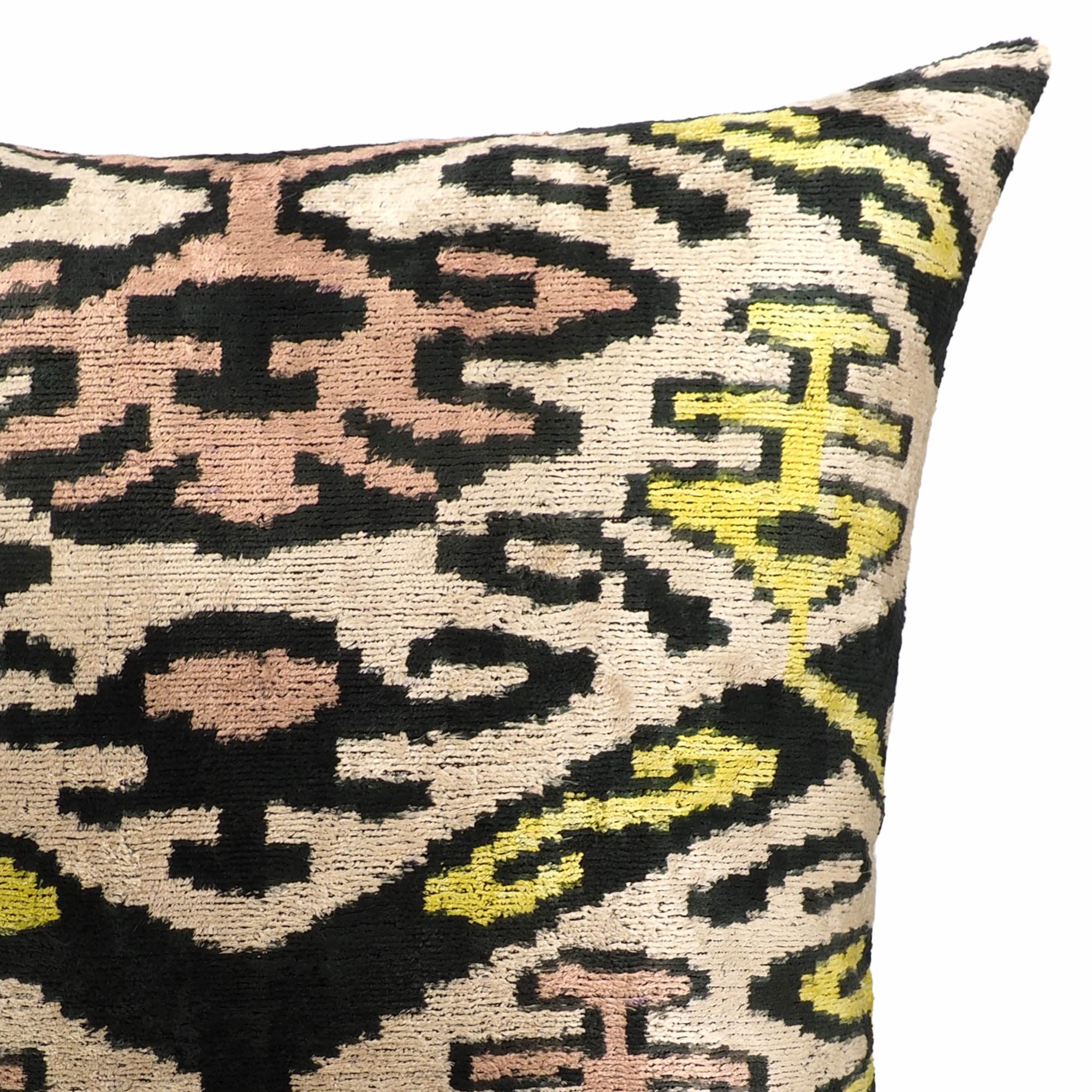 20-inch square ikat throw pillow featuring geometric motifs in gold, pink, and green tones.