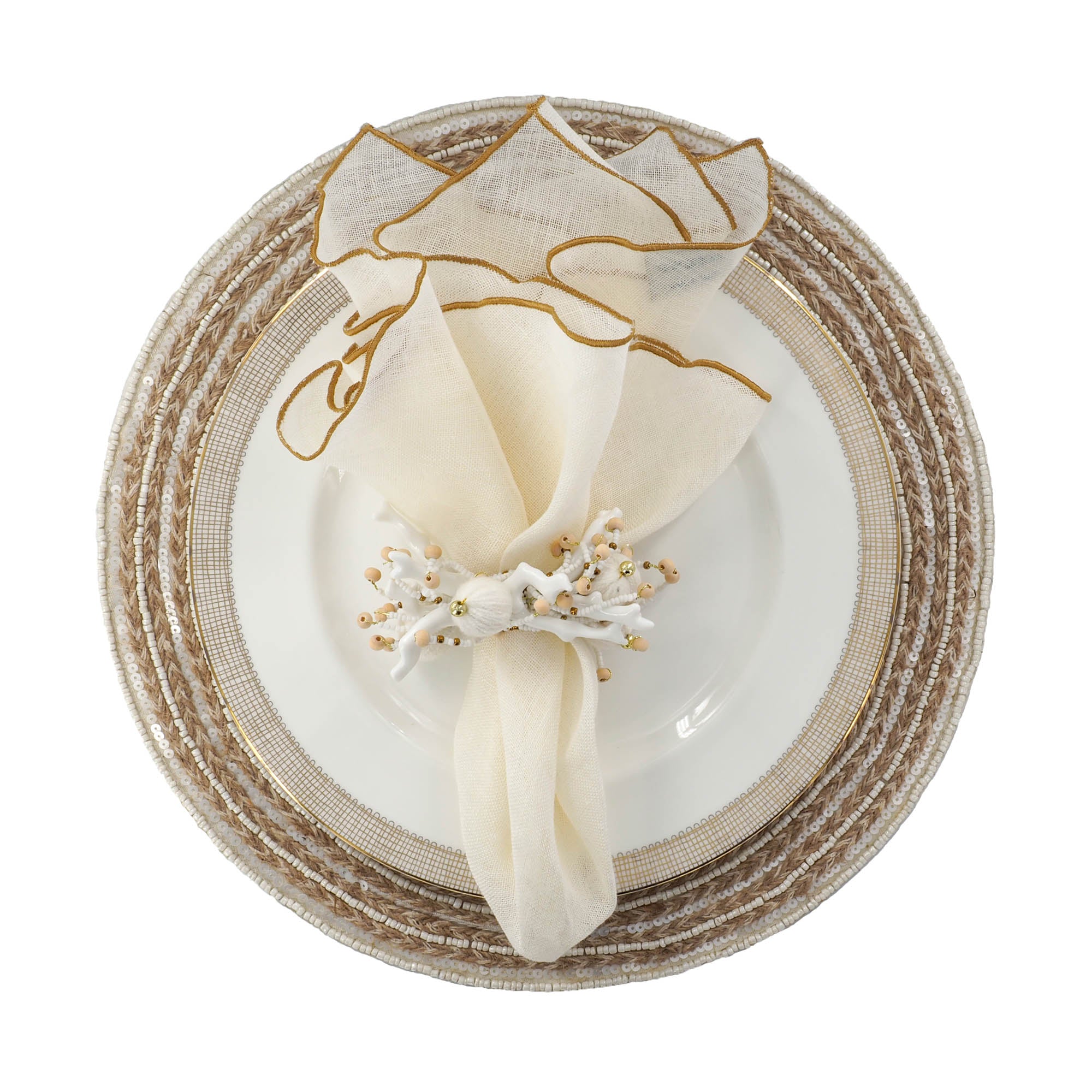 Luxury dining setup featuring handmade braided jute placemat with white and ivory beads , styled with ivory linen napkin and white napkin ring by ChouChou Touch