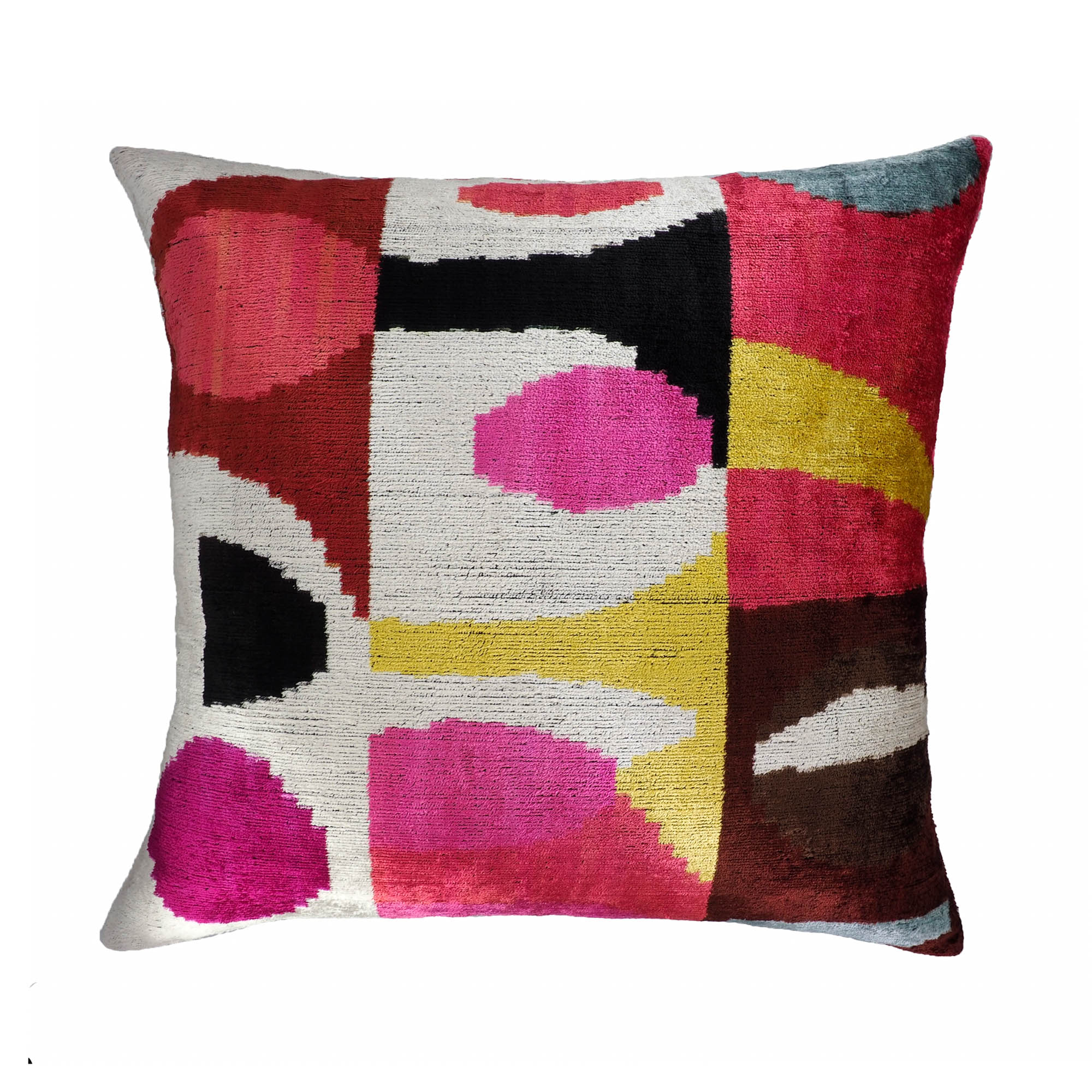 Colorful abstract silk velvet ikat pillow in fuchsia, mustard, red, and black geometric shapes.