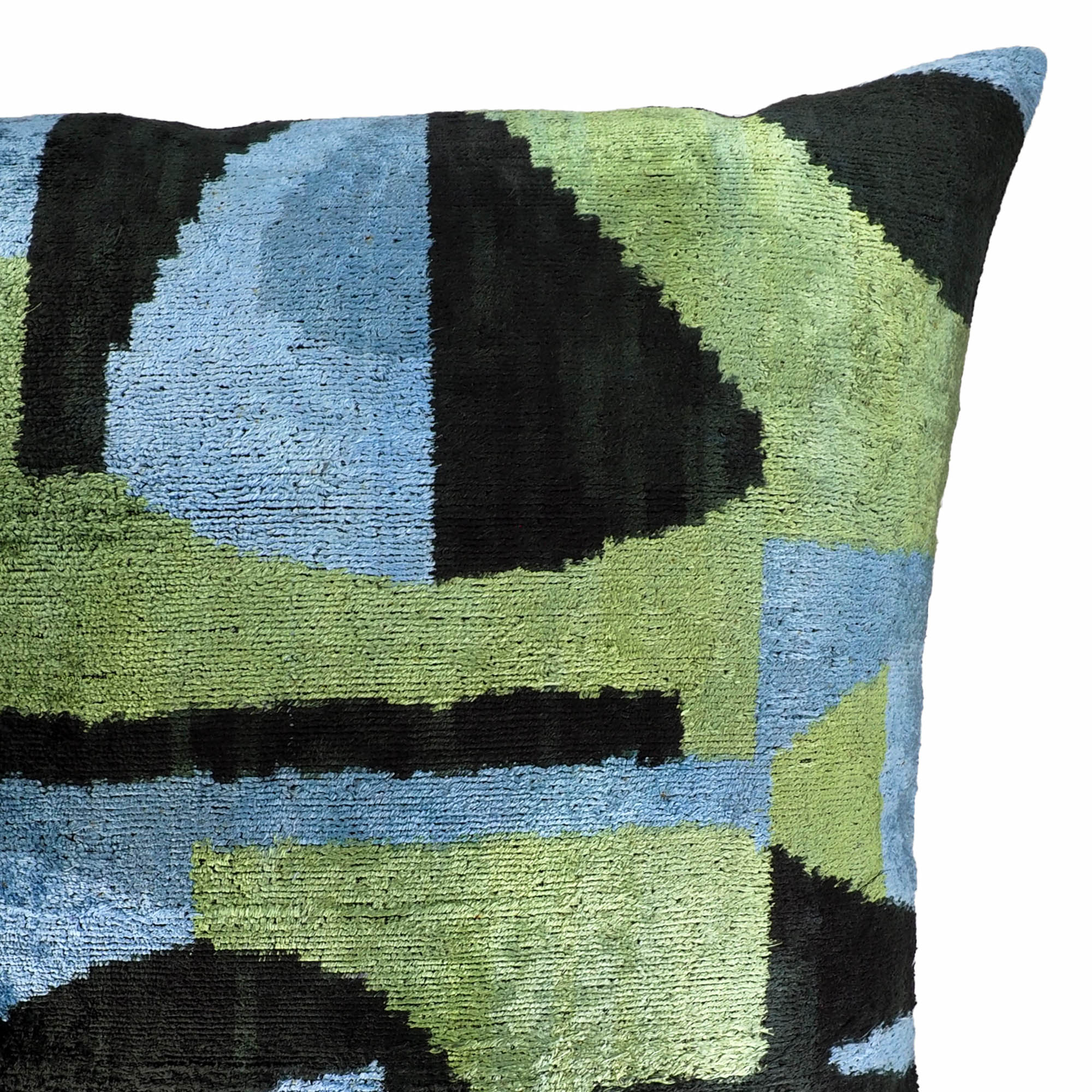 Handwoven 24-inch silk pillow featuring abstract ikat design in nature-inspired greens and blues.
