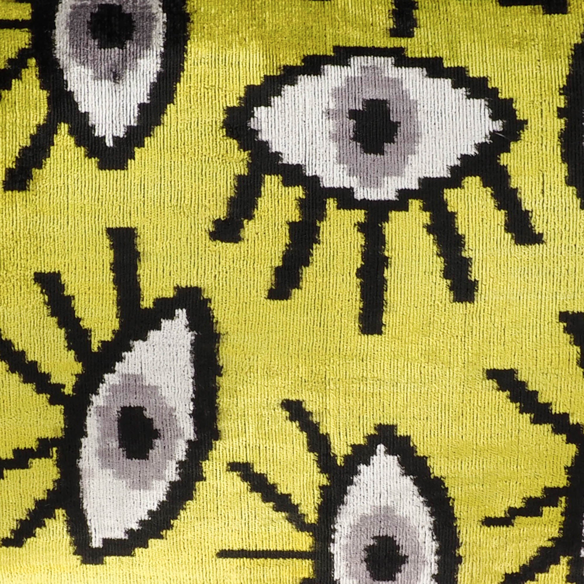 Chouchou Touch Yellow Eyes Silk Velvet Ikat Pillow Cover, 16 x 24, made from 100% pure silk with handwoven Ikat patterns, offering a colorful and tactile accent for your sofa.