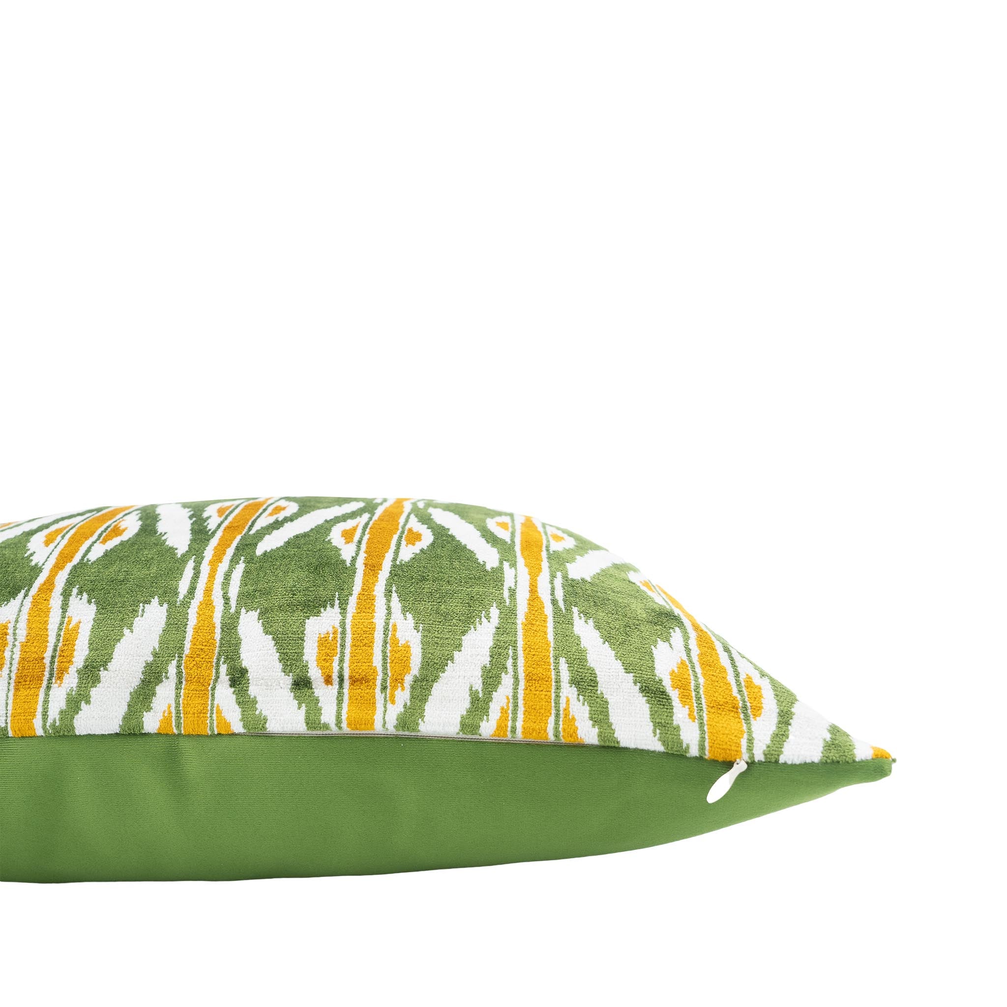 Handwoven green and white ikat pillow with golden yellow accents, made from pure silk velvet.