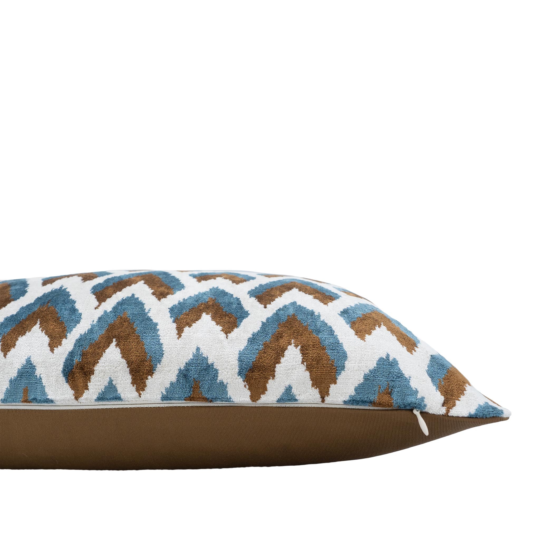 Handmade rectangular ikat pillow with arrow motif in earthy tones and blue.