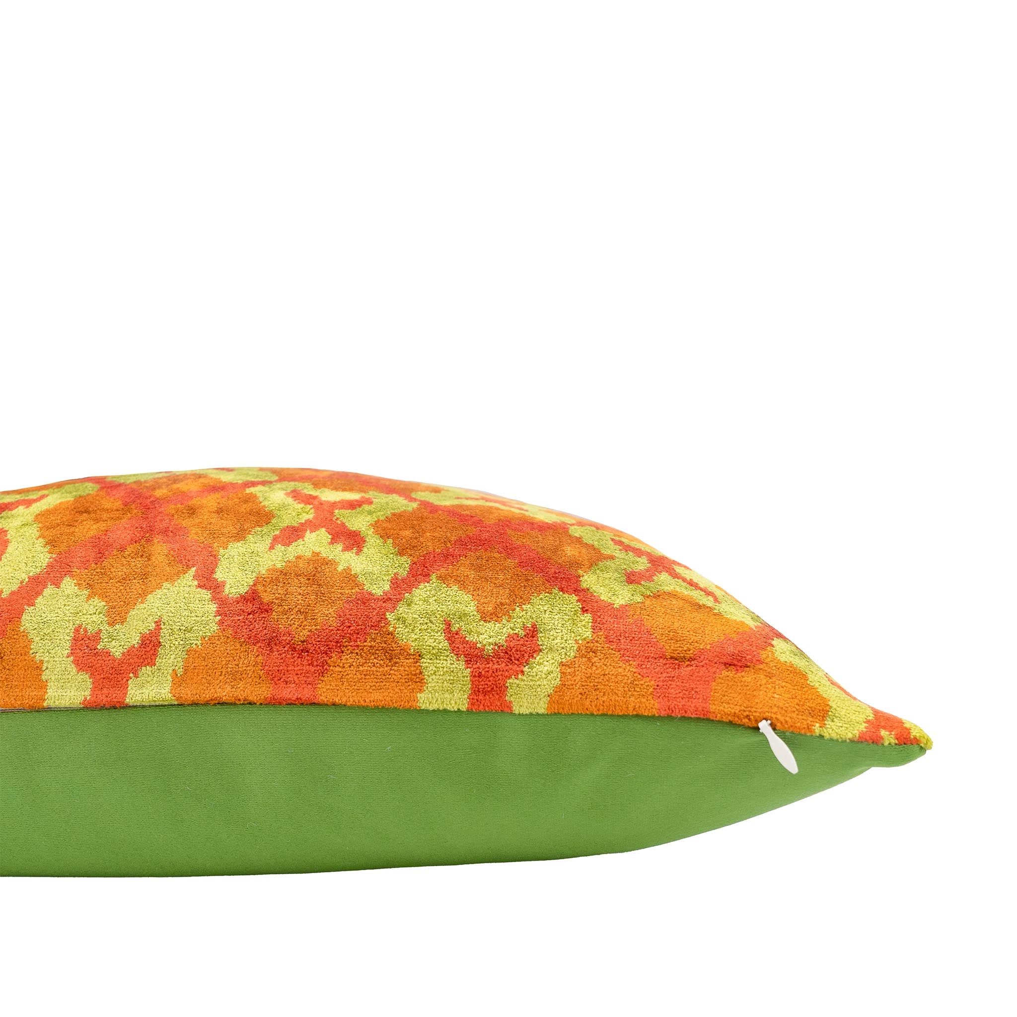 Handwoven silk velvet ikat pillow featuring a vibrant orange and gold interwoven design.