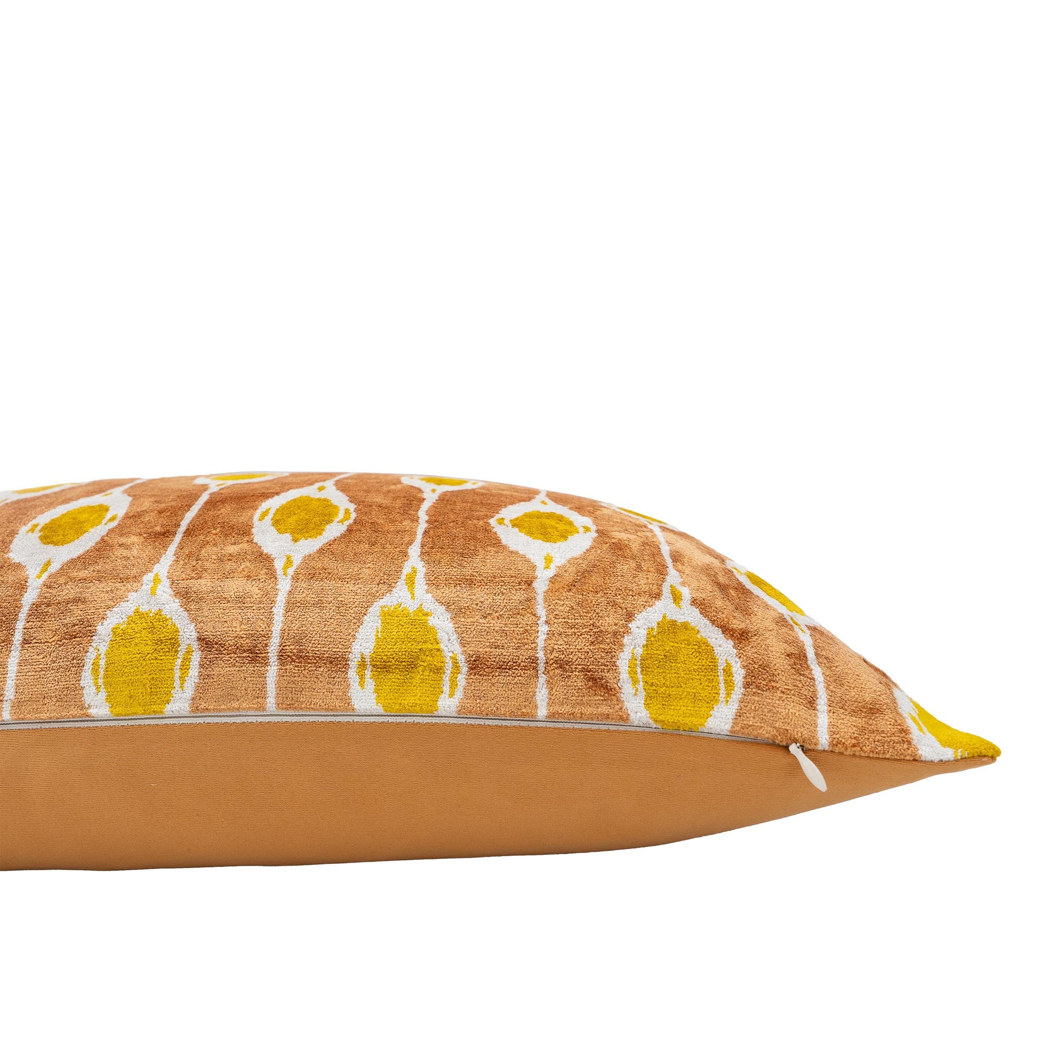 Golden brown Chouchou Touch pillow cover with vibrant yellow ikat design.