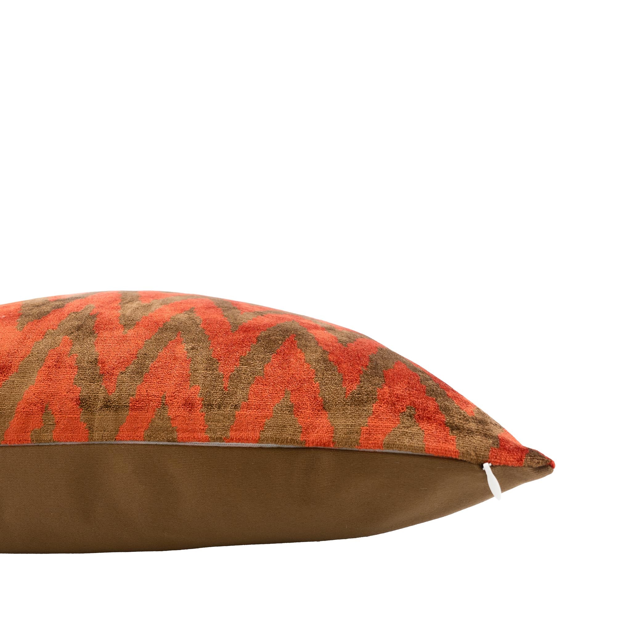 Handwoven silk velvet ikat pillow featuring a striking chevron design in warm earthy tones.
