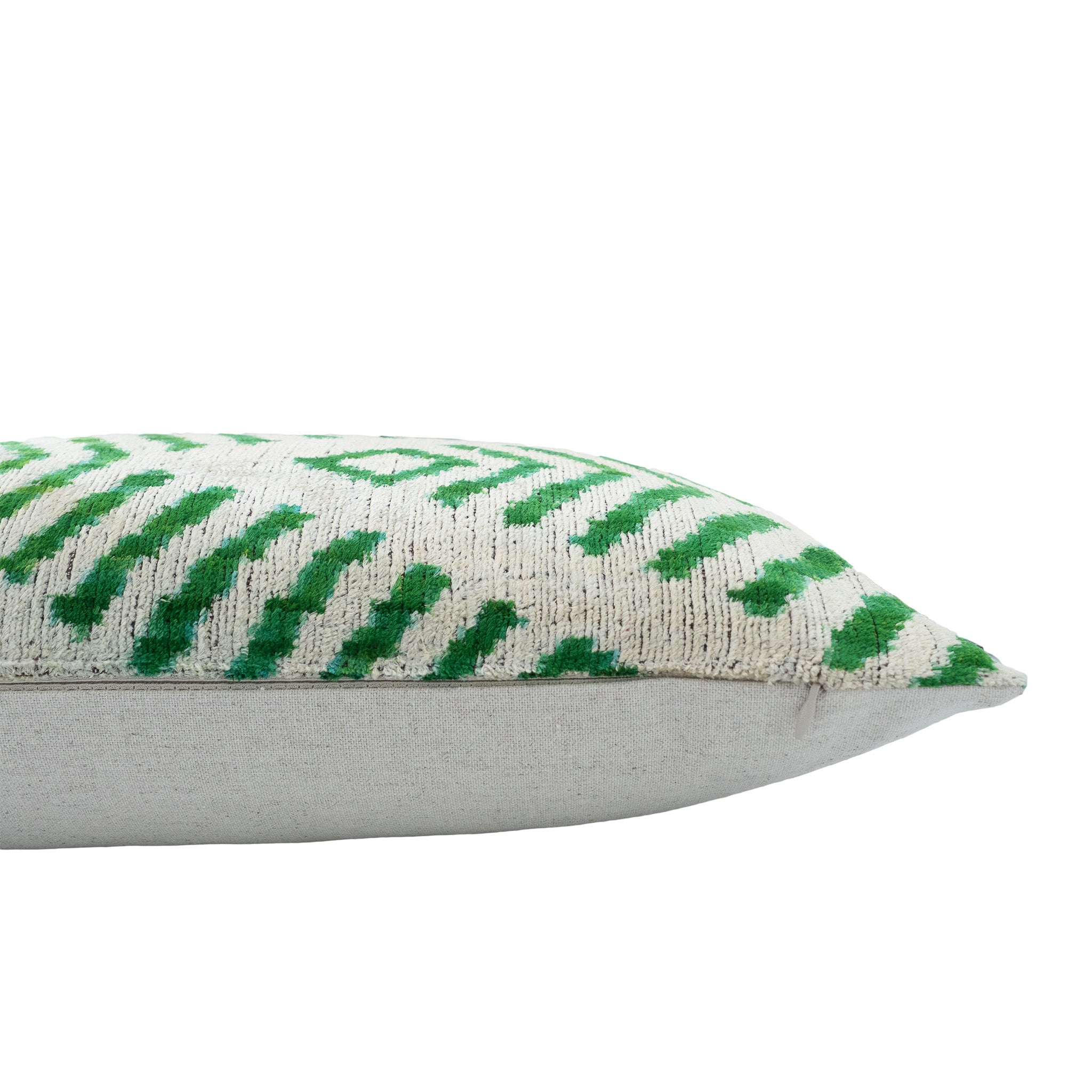 Handwoven 16x24-inch silk velvet ikat pillow featuring a modern arrow motif in lush green tones.