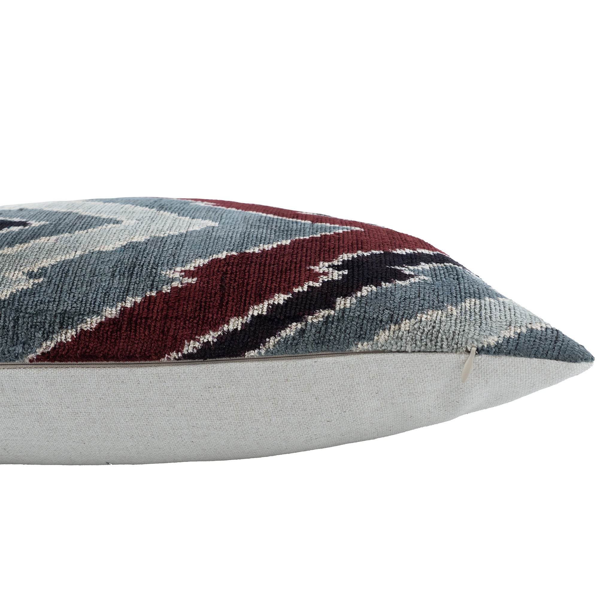 Handwoven silk velvet throw pillow featuring bold chevron stripes in earthy tones.