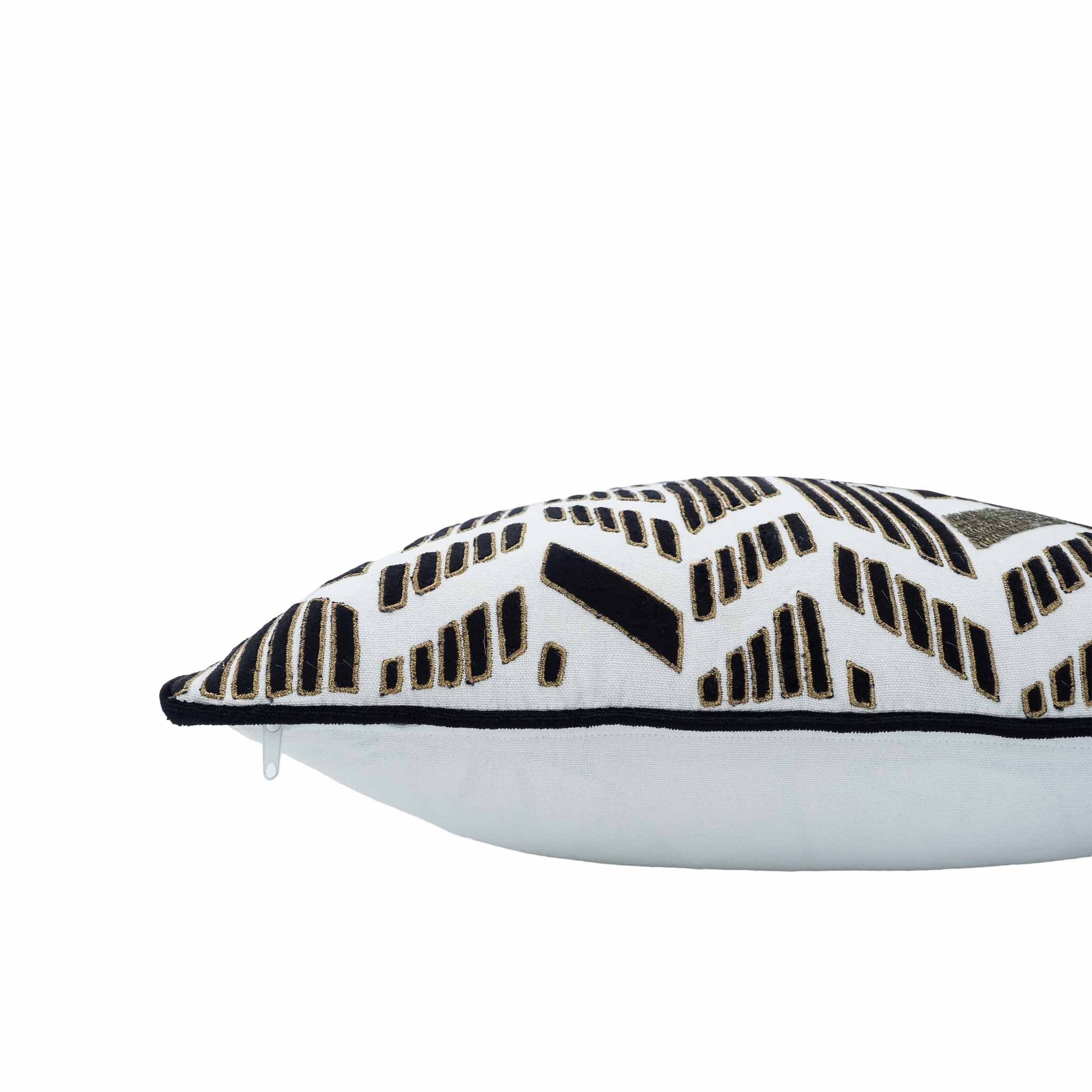 White linen cushion with black and gold sequin detailing in geometric chevron design.