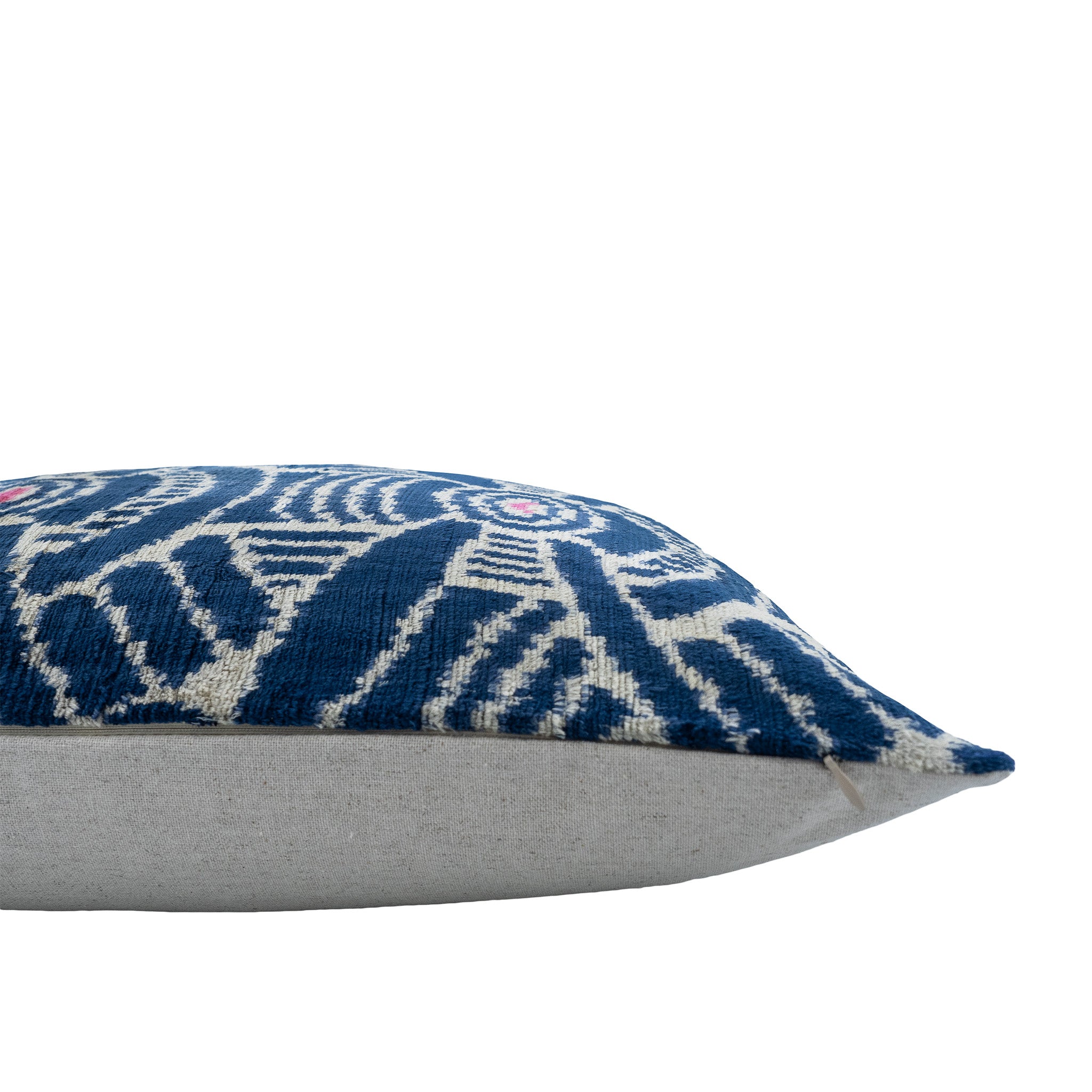 Handwoven Kelly Ikat pillow cover crafted from 100% silk velvet, featuring intricate blue and white designs with pink details.