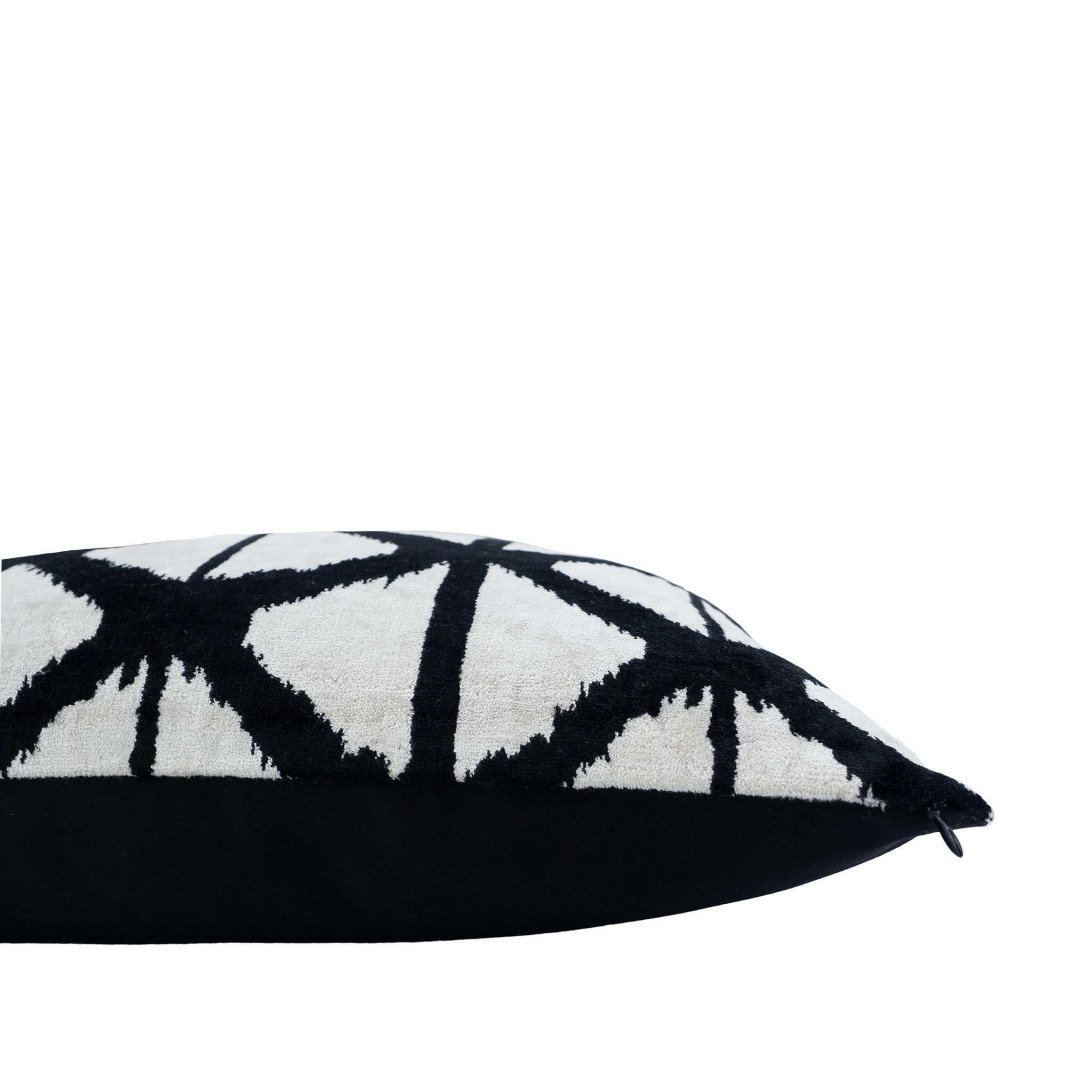 Luxurious black and white geometric-patterned throw pillow in silk velvet, measuring 20" x 20".