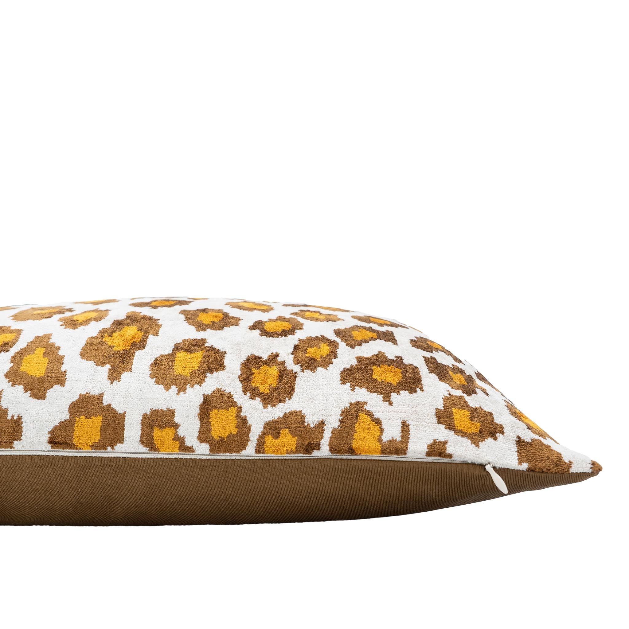 Chouchou Touch ikat throw pillow featuring a bold leopard spot pattern on white silk velvet.