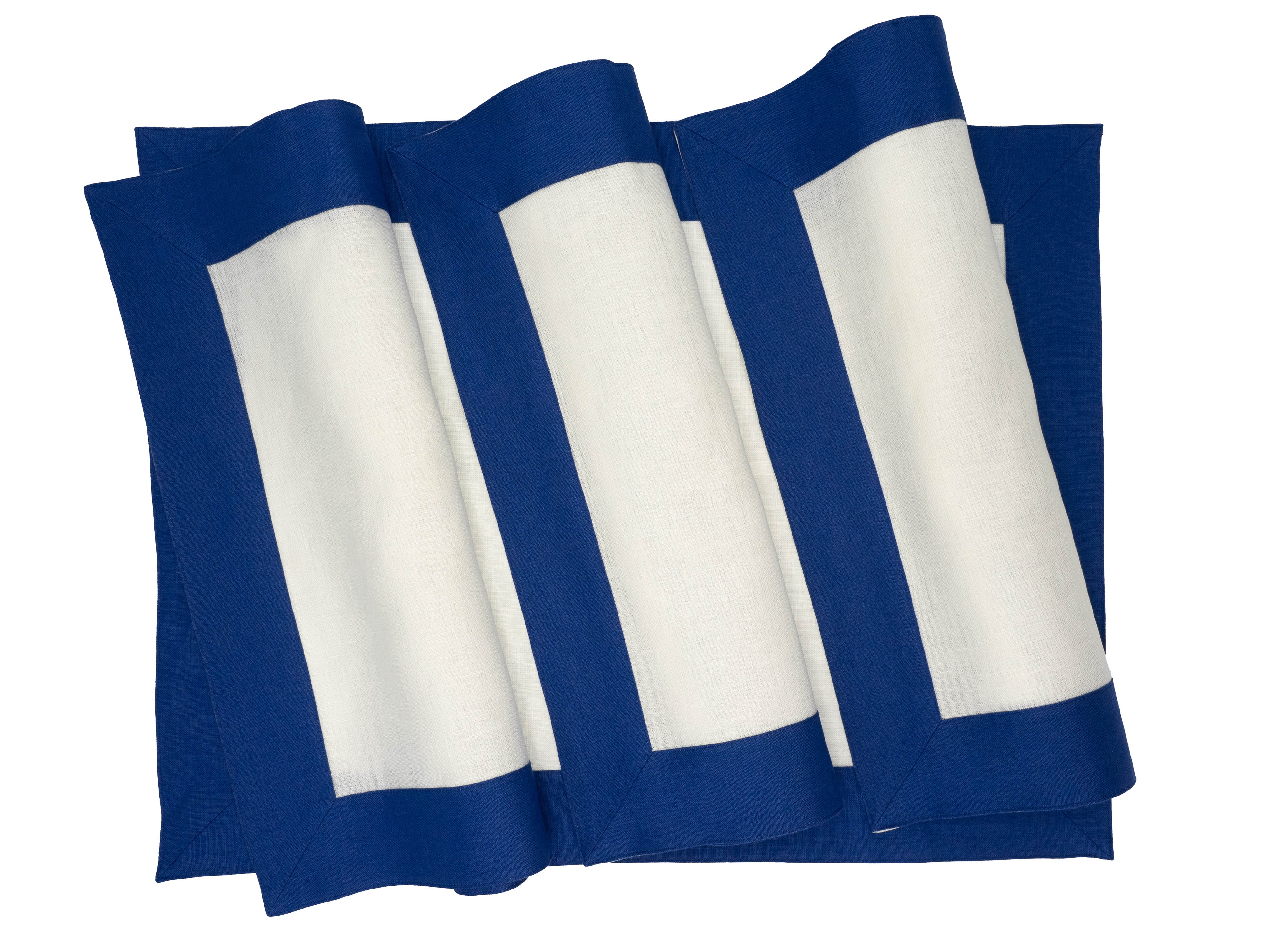 Chouchou Touch navy-bordered linen placemats, handmade with attention to detail for a stylish and timeless addition to your table.